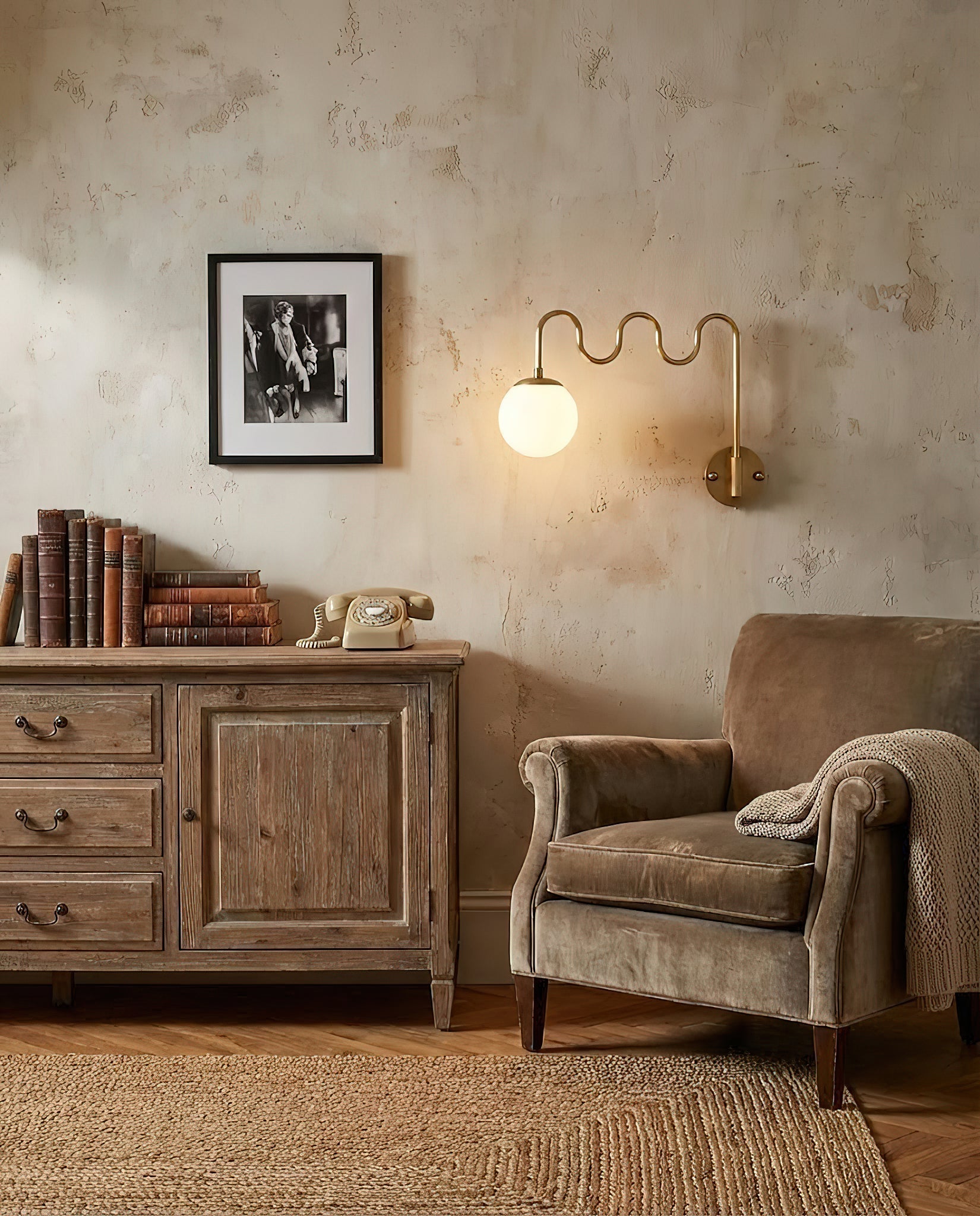 Side view of the Cecil Wall Sconce showing the undulating brass arm.