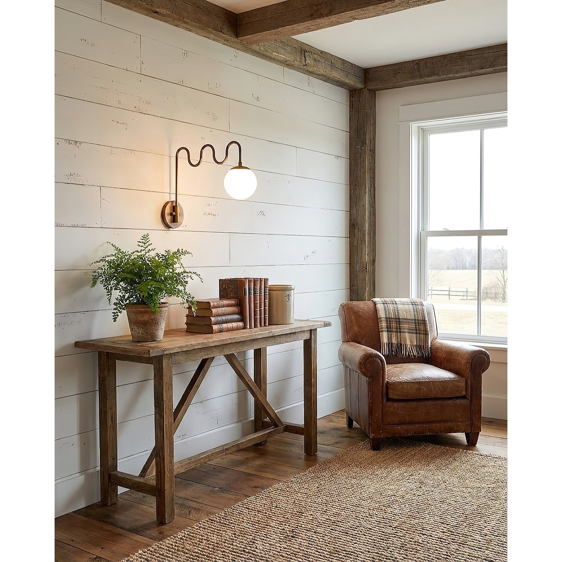 The Cecil Wall Sconce installed above a bedside table.