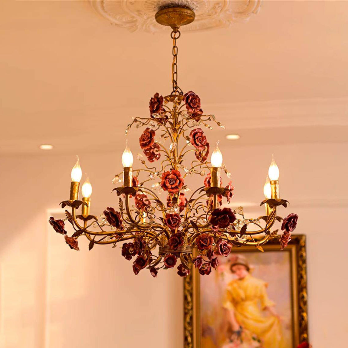 Copper finish chandelier styled against a dark wall.