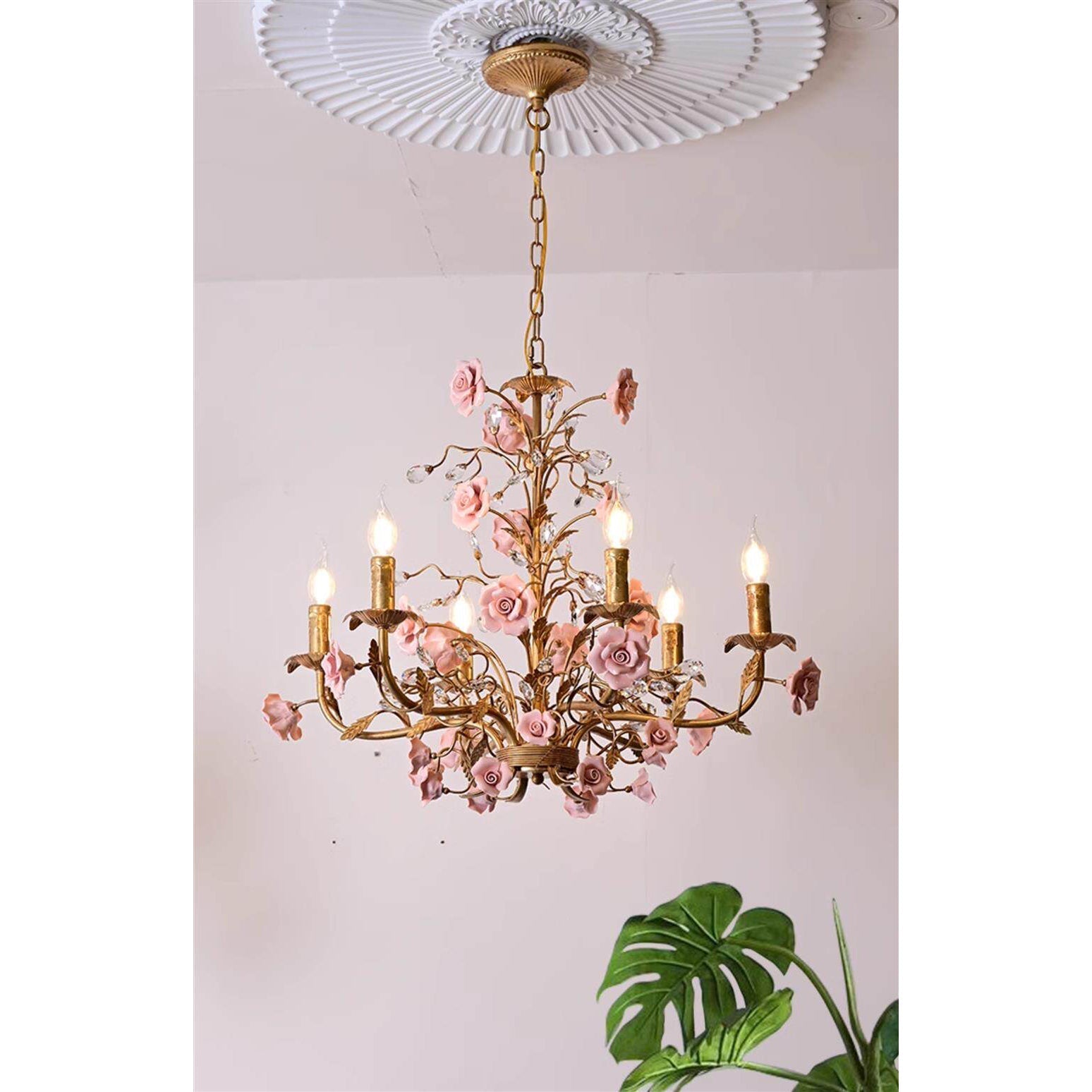 The chandelier's botanical vine structure in a copper finish.