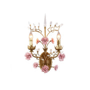 Ceramic rose vine wall sconce in a delicate pink finish.
