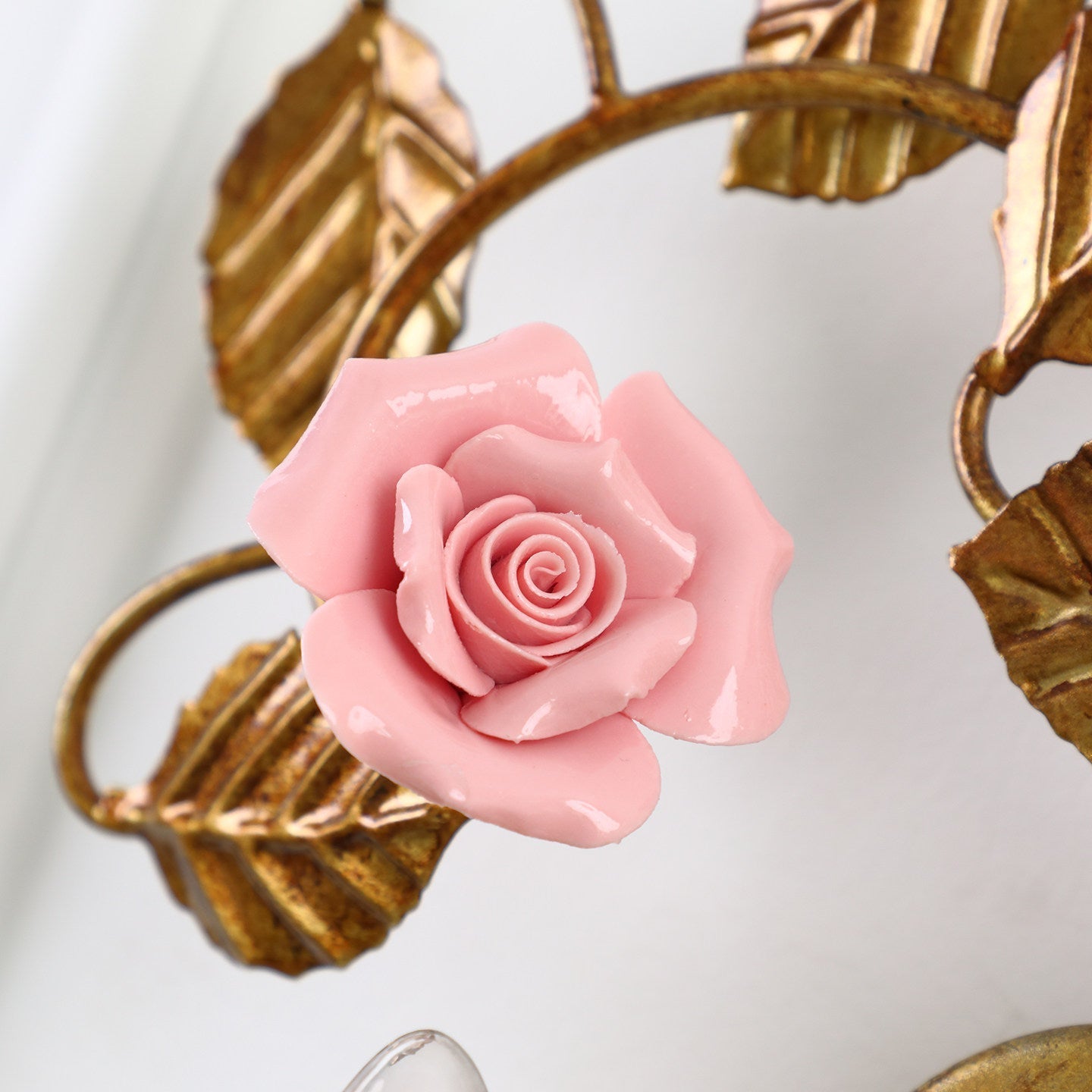 The ceramic rose sconce installed in a chic entryway.