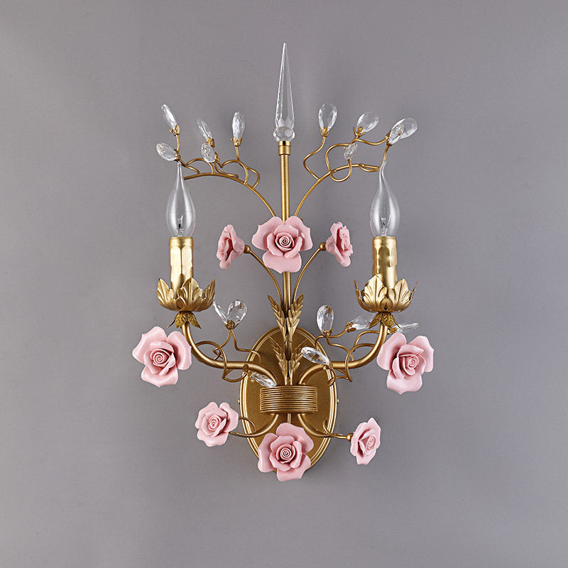 Unlit view of the pink ceramic sconce showcasing its form.