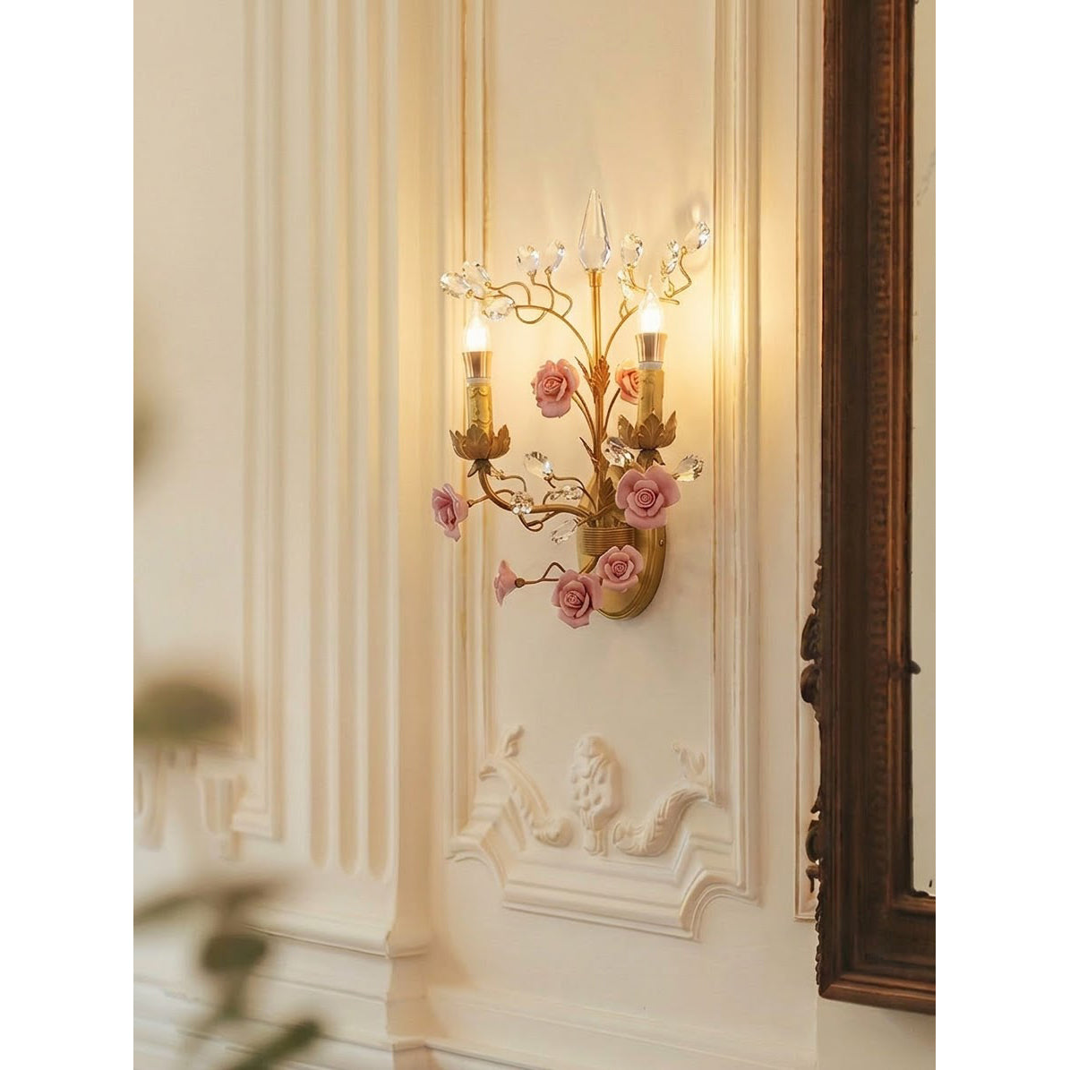 The wall sconce displayed against a dark wall for dramatic contrast.