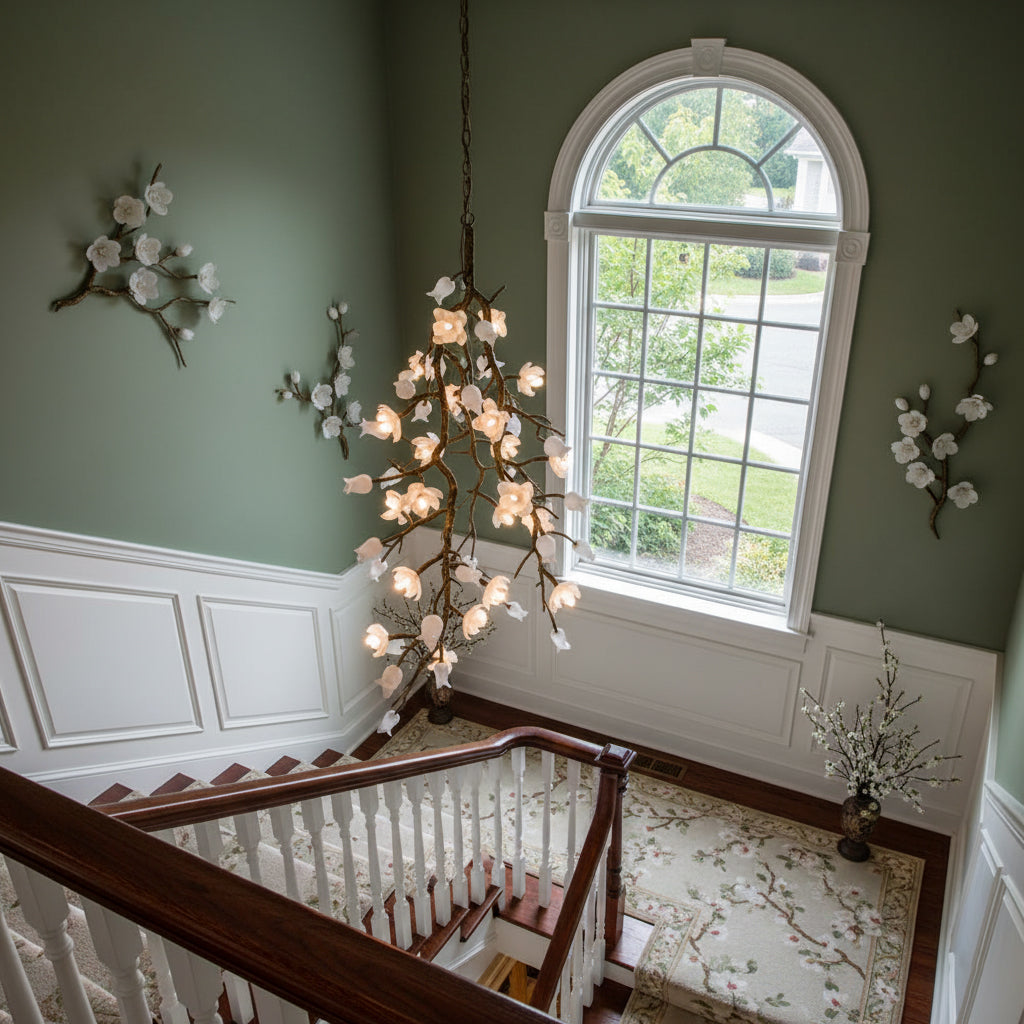 The Cascading Blossom Chandelier installed in a modern, double-height stairwell.