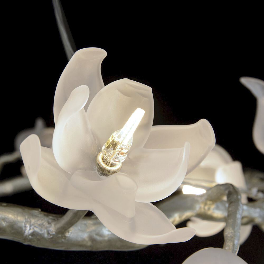 Macro detail of the brushed silver finish on the brass branches.