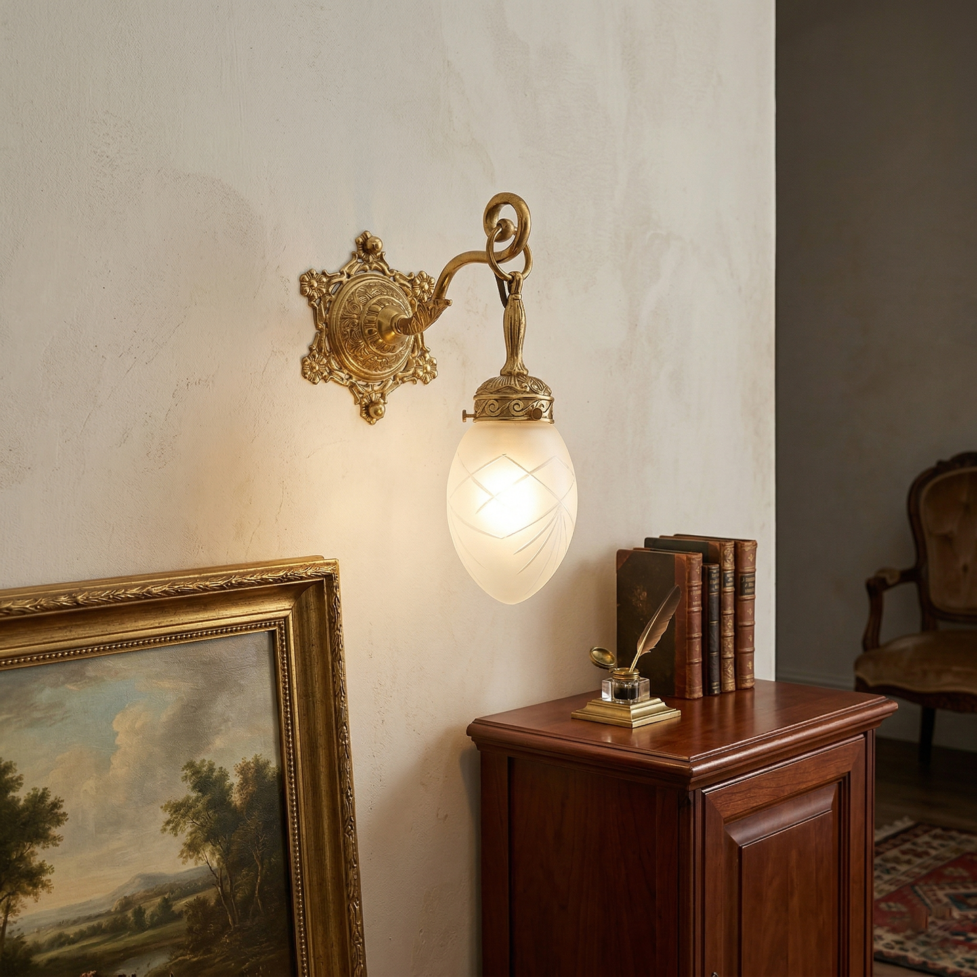 Detail shot of the polished brass body and arm of the wall lamp.