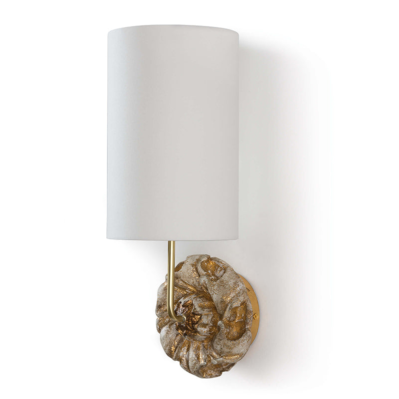 The Claudia Wall Lamp illuminated, casting a warm light.
