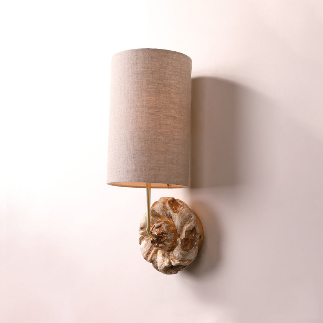 Close-up of the Claudia Wall Lamp's fabric shade and gold details.