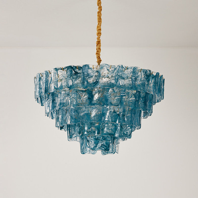 Clementine chandelier casting a warm, inviting glow in a stylish interior.