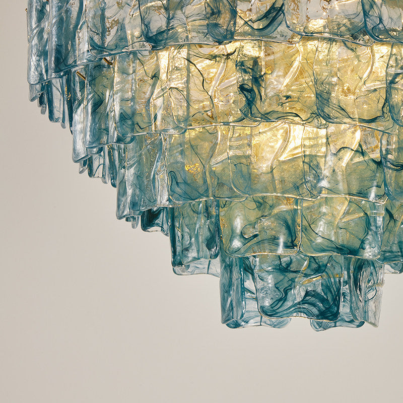 Clementine chandelier with gold-tinted glass panels in a luxurious living room setting.