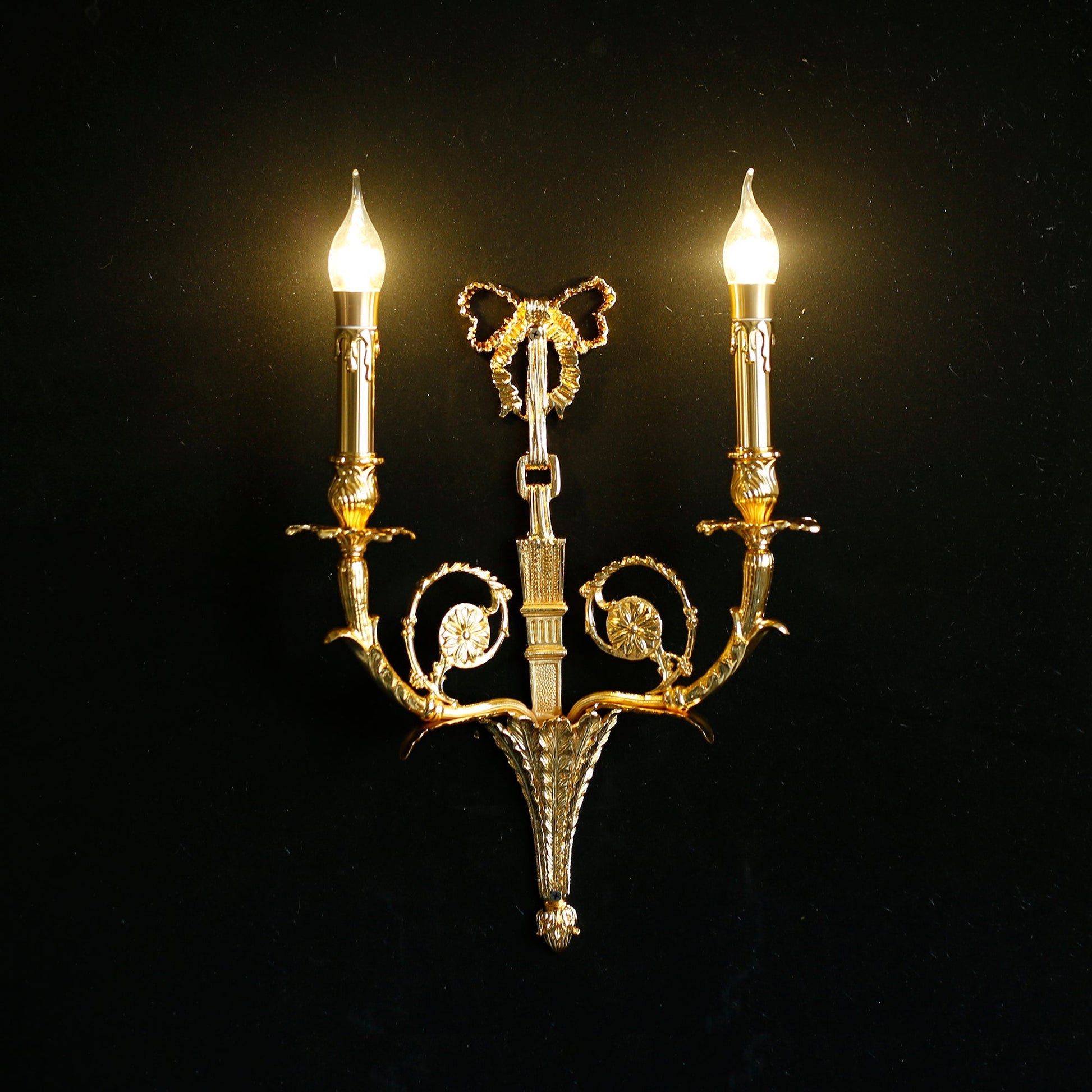 The sconce shown with candelabra bulbs to illustrate lighting effect.