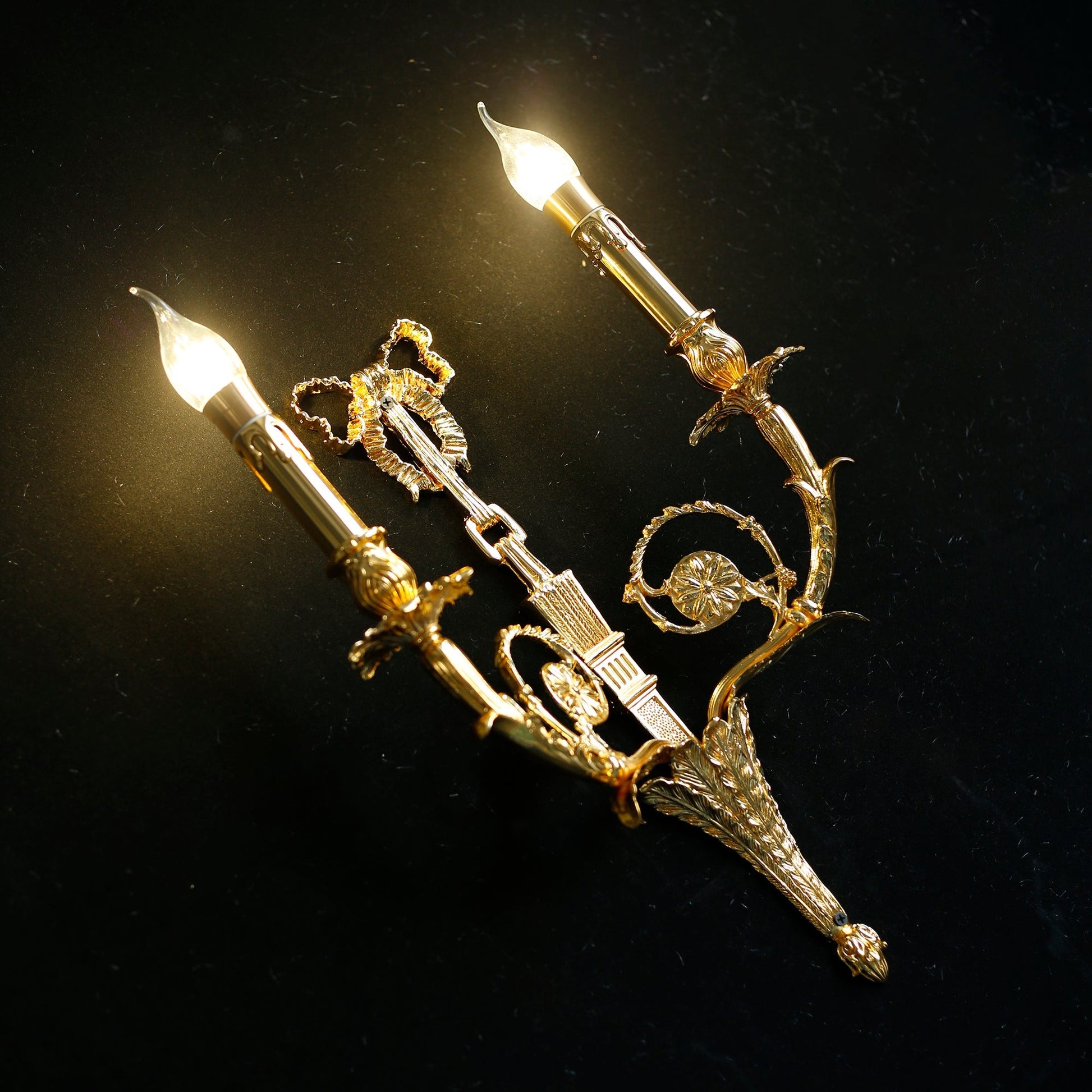 The sconce casting elegant shadows on a wall.