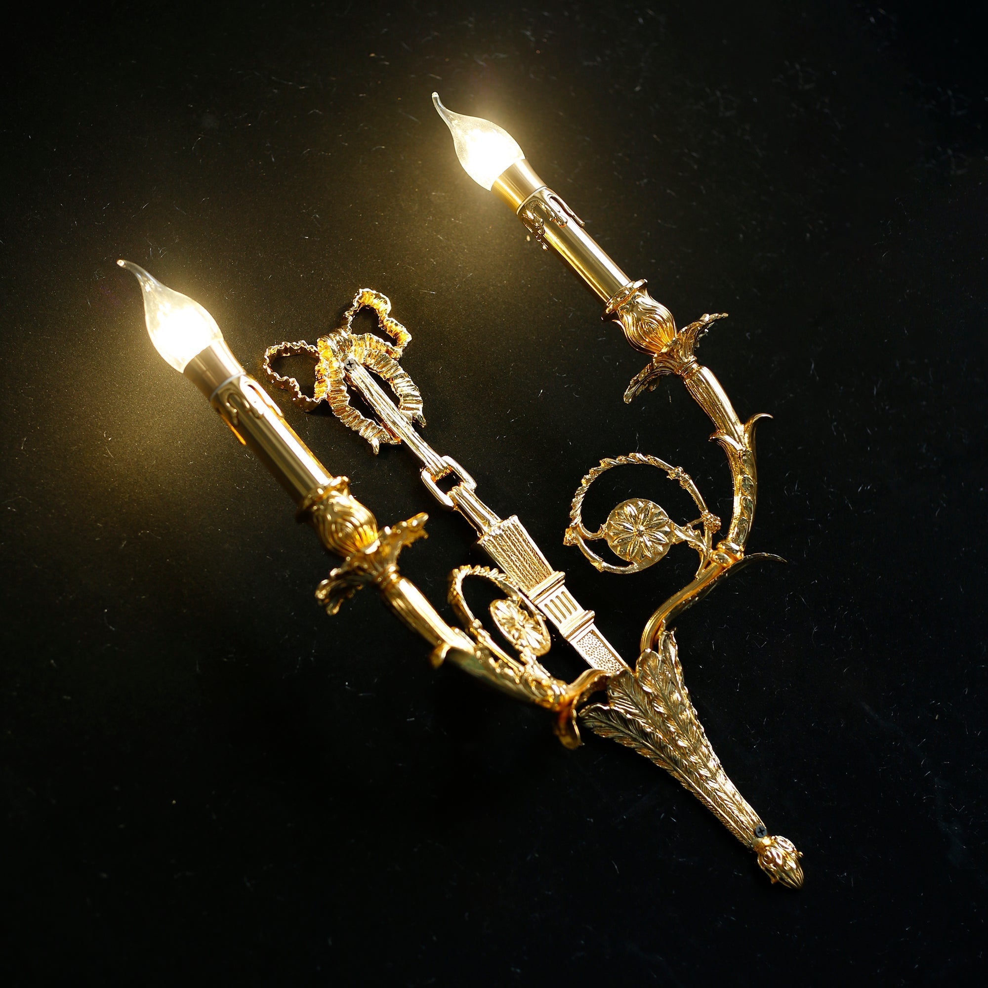 The sconce casting elegant shadows on a wall.