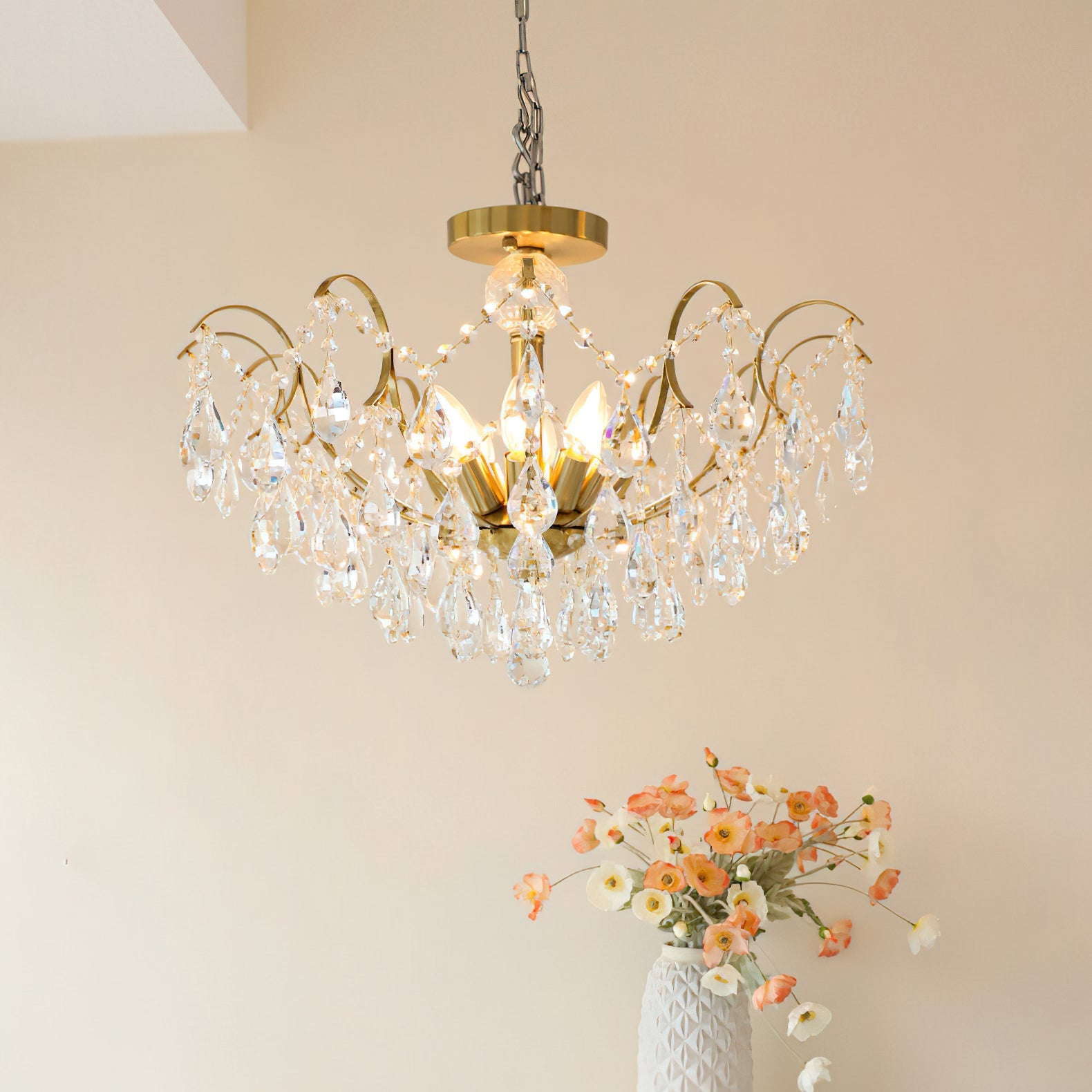 The chandelier against a dark background, highlighting the crystal sparkle.