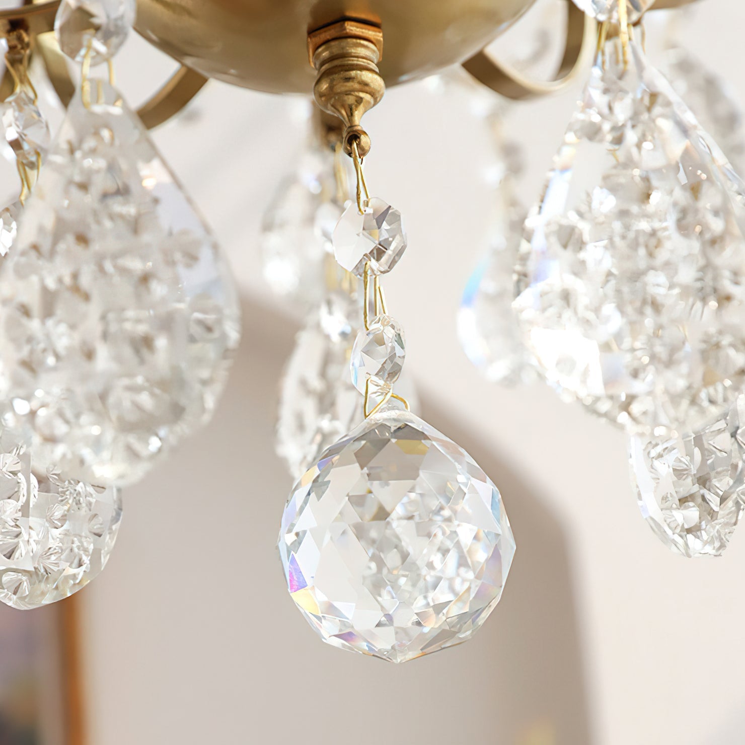 The chandelier unlit, showing the clarity of the crystal prisms.