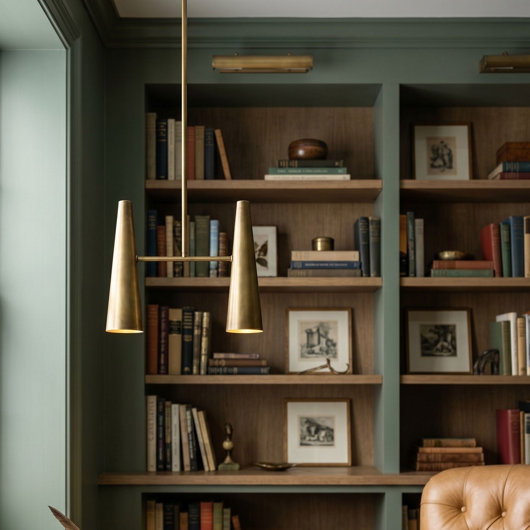 Angled view of the two-headed Cono Pendant Lamp in brass.