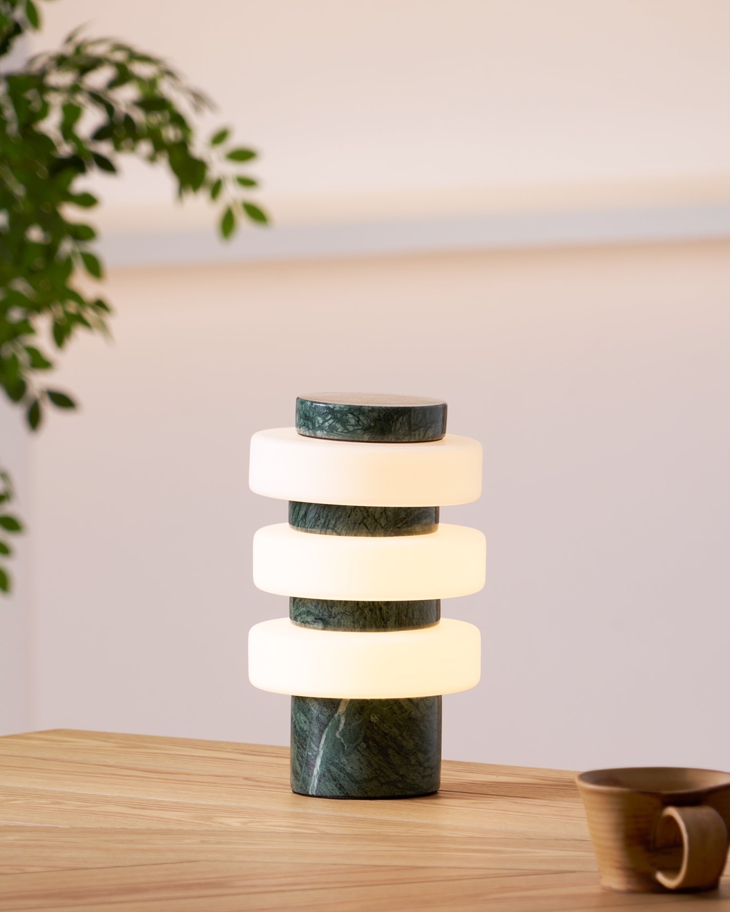 Corba Table Lamp in green, showcasing its unique architectural design.