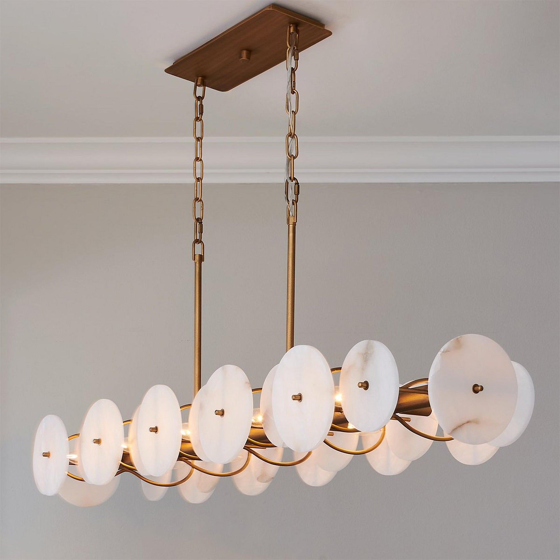 Lifestyle image of the Selene chandelier in a luxury hotel suite living room.