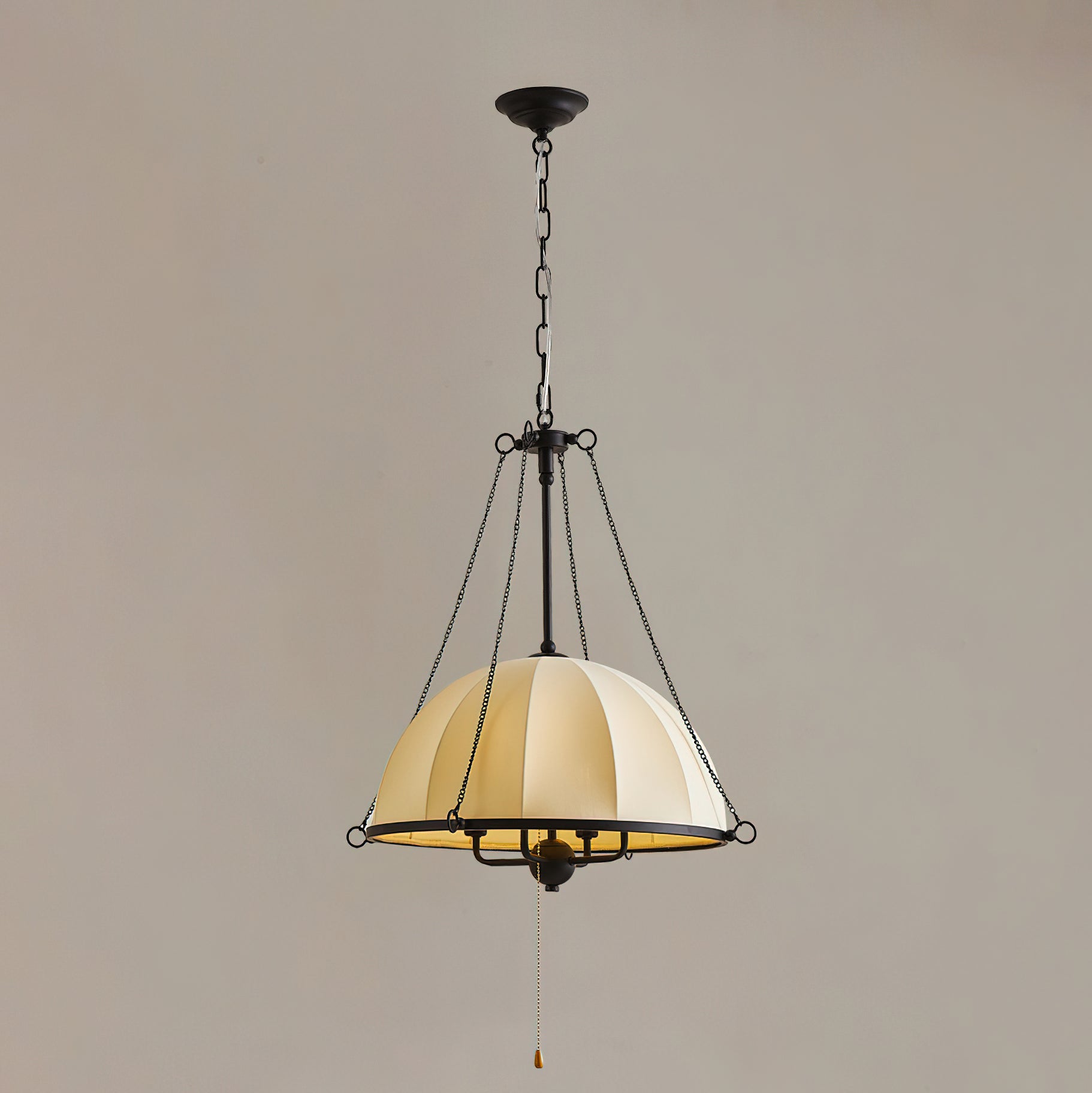 The Covina Pendant Lamp illuminated in a dark room.