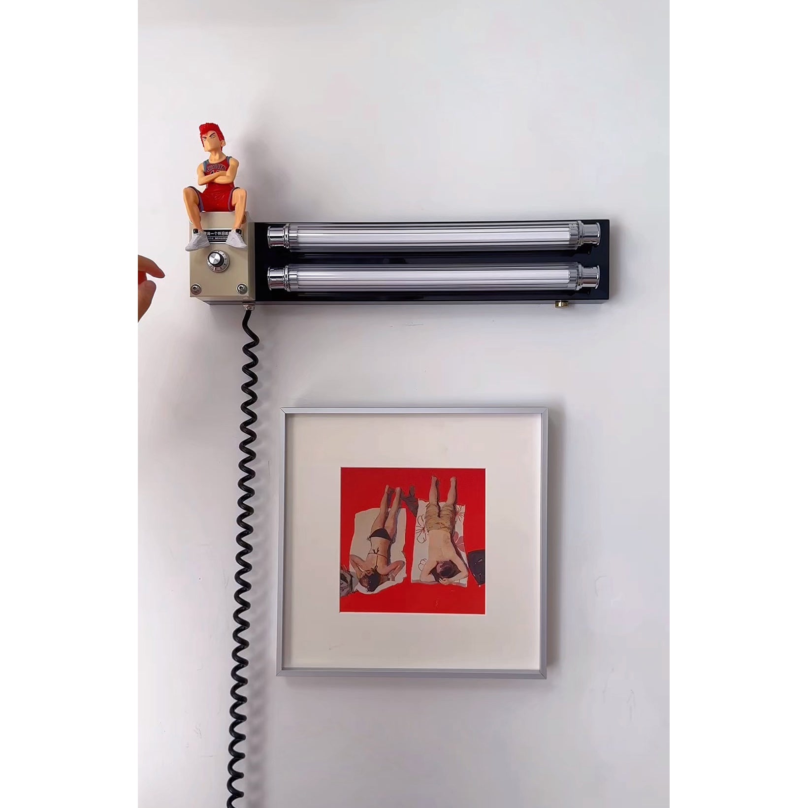 The Cutshall Wall Lamp installed above a bedside table.