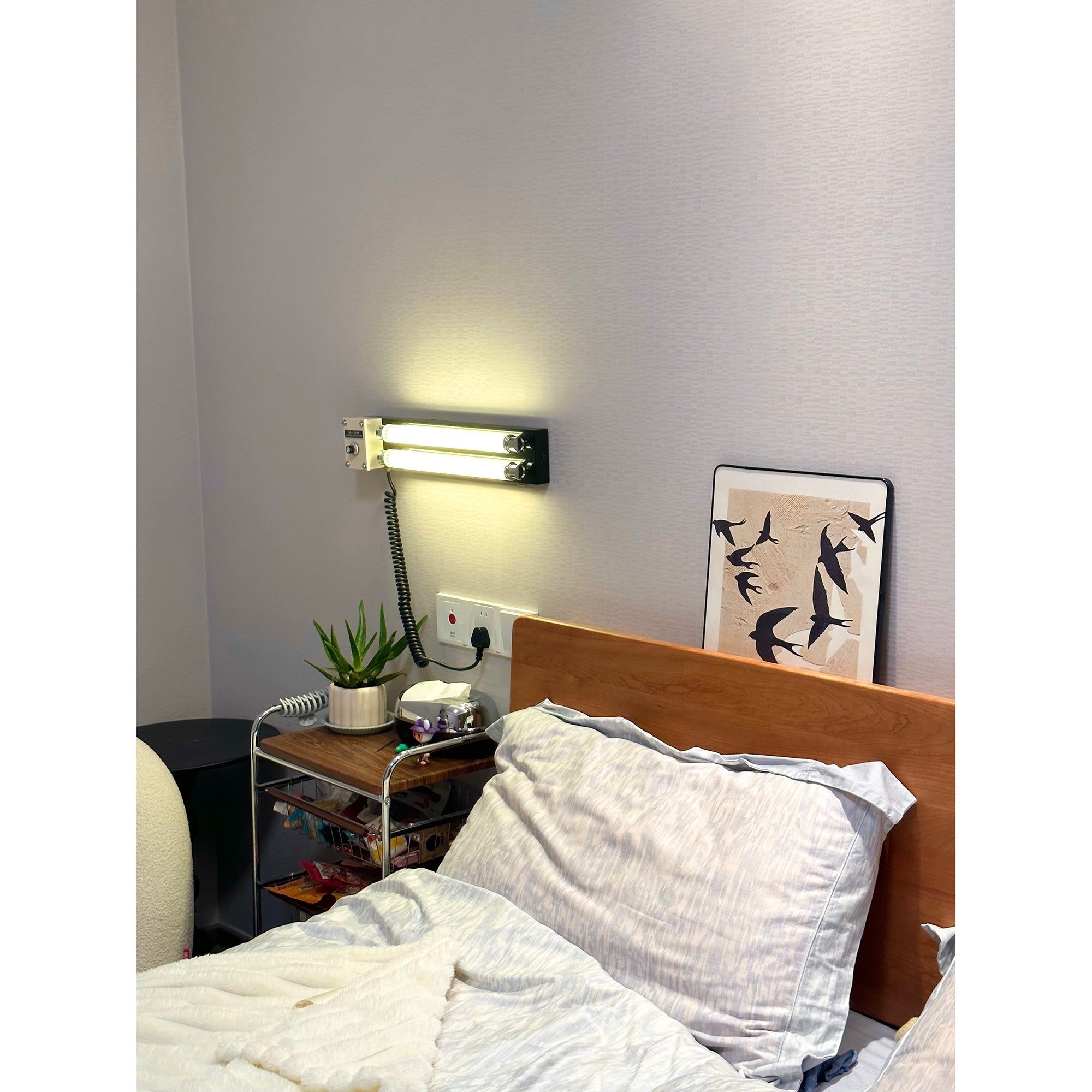 Cutshall Plug-in Wall Lamp, orange, angled view.