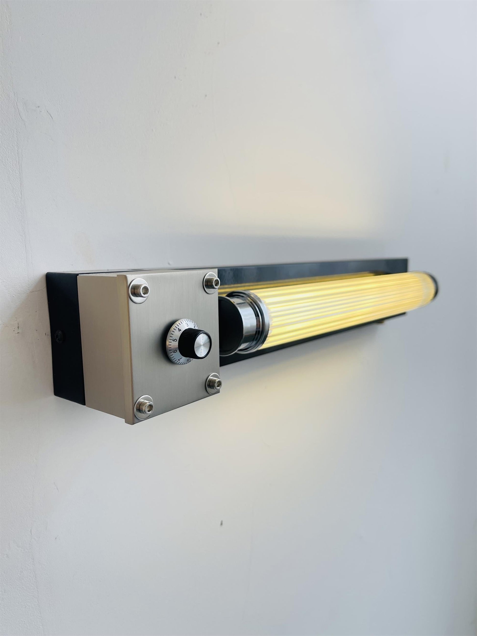 Cutshall Wall Lamp in Orange finish, angled view.