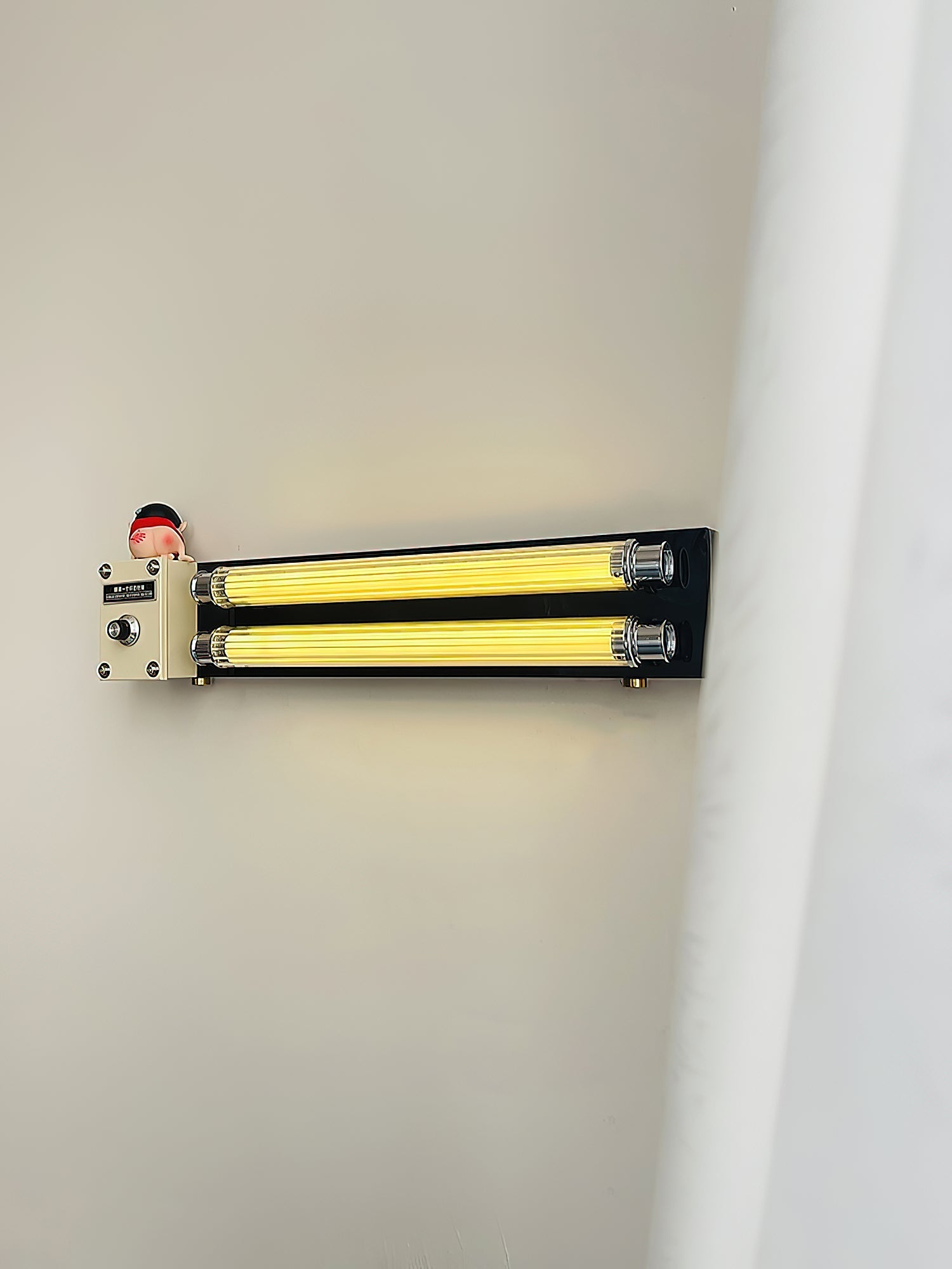 Detail shot of the metal body of the Cutshall Wall Lamp.