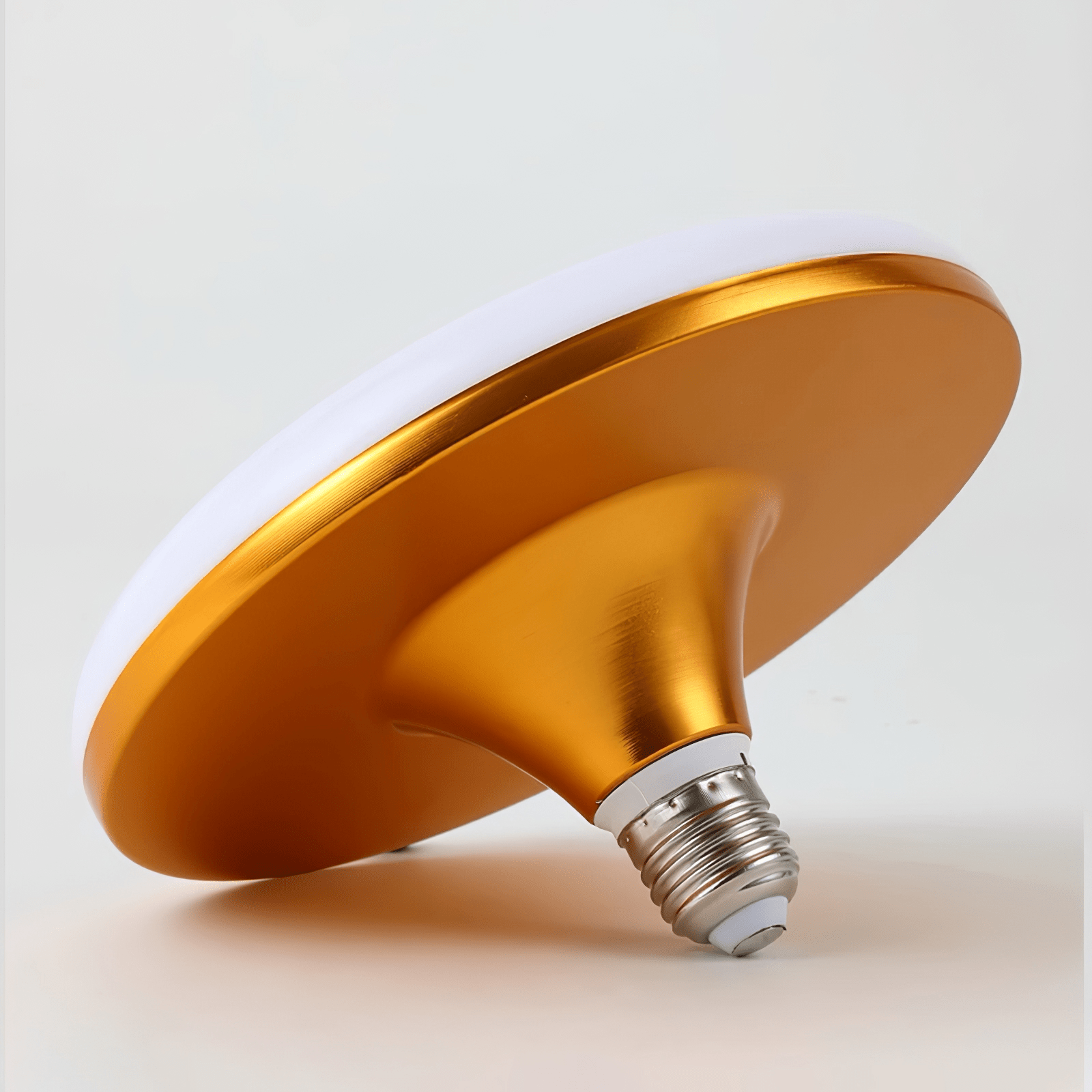 Flying saucer LED bulb illuminated, casting a soft, even glow.