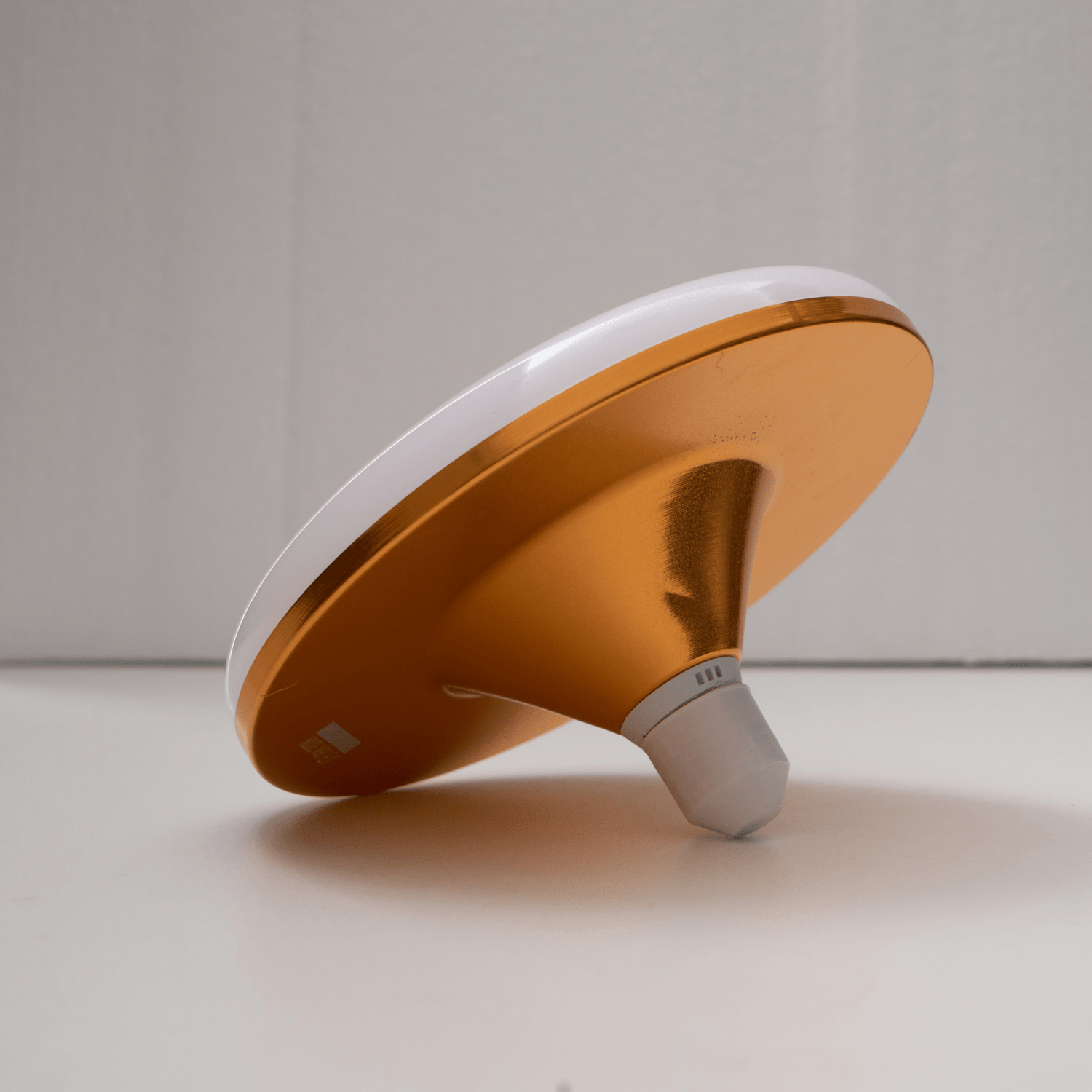 Angled view of the flying saucer E27 LED bulb against a neutral background.