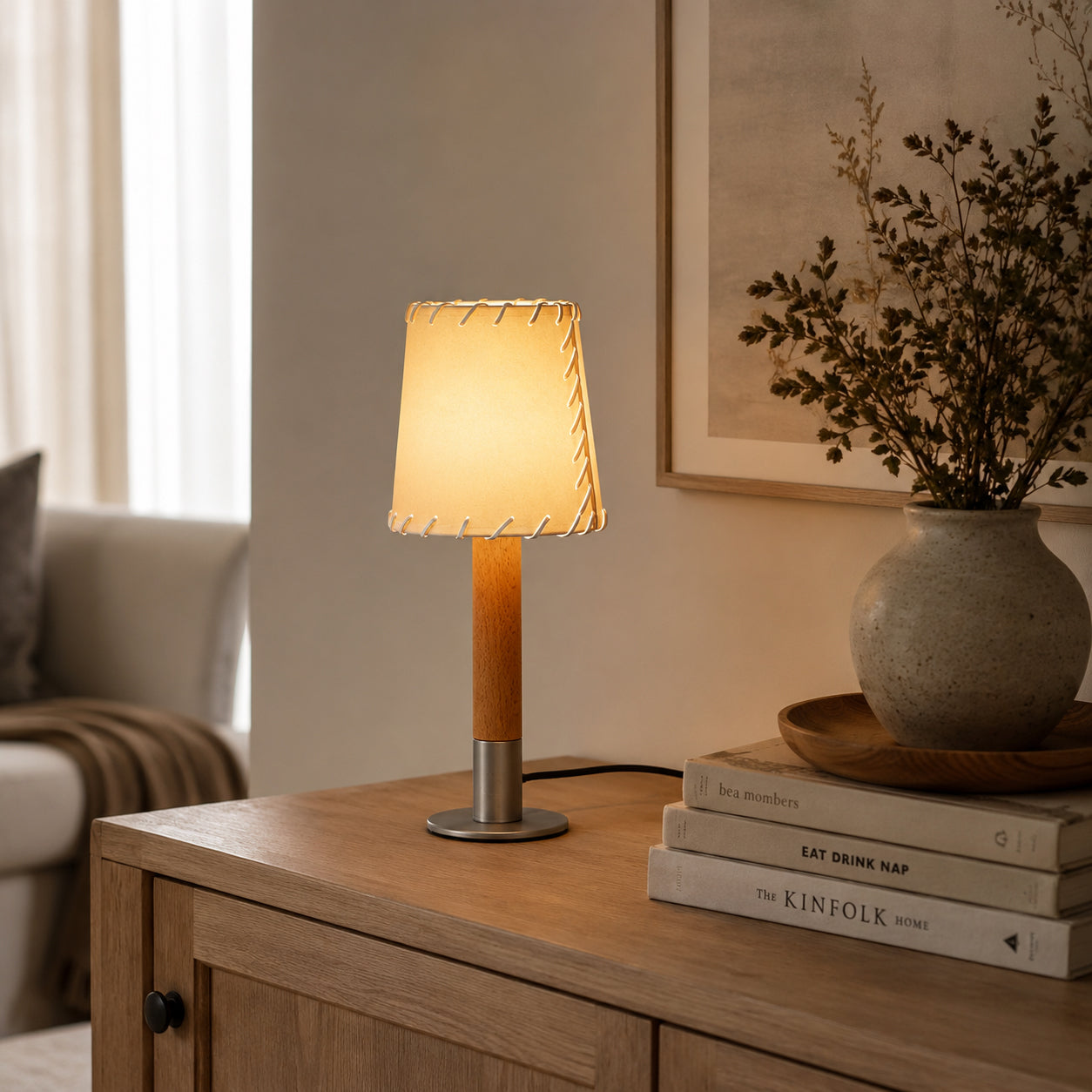 Detail shot of the brushed metal base and natural wood column.