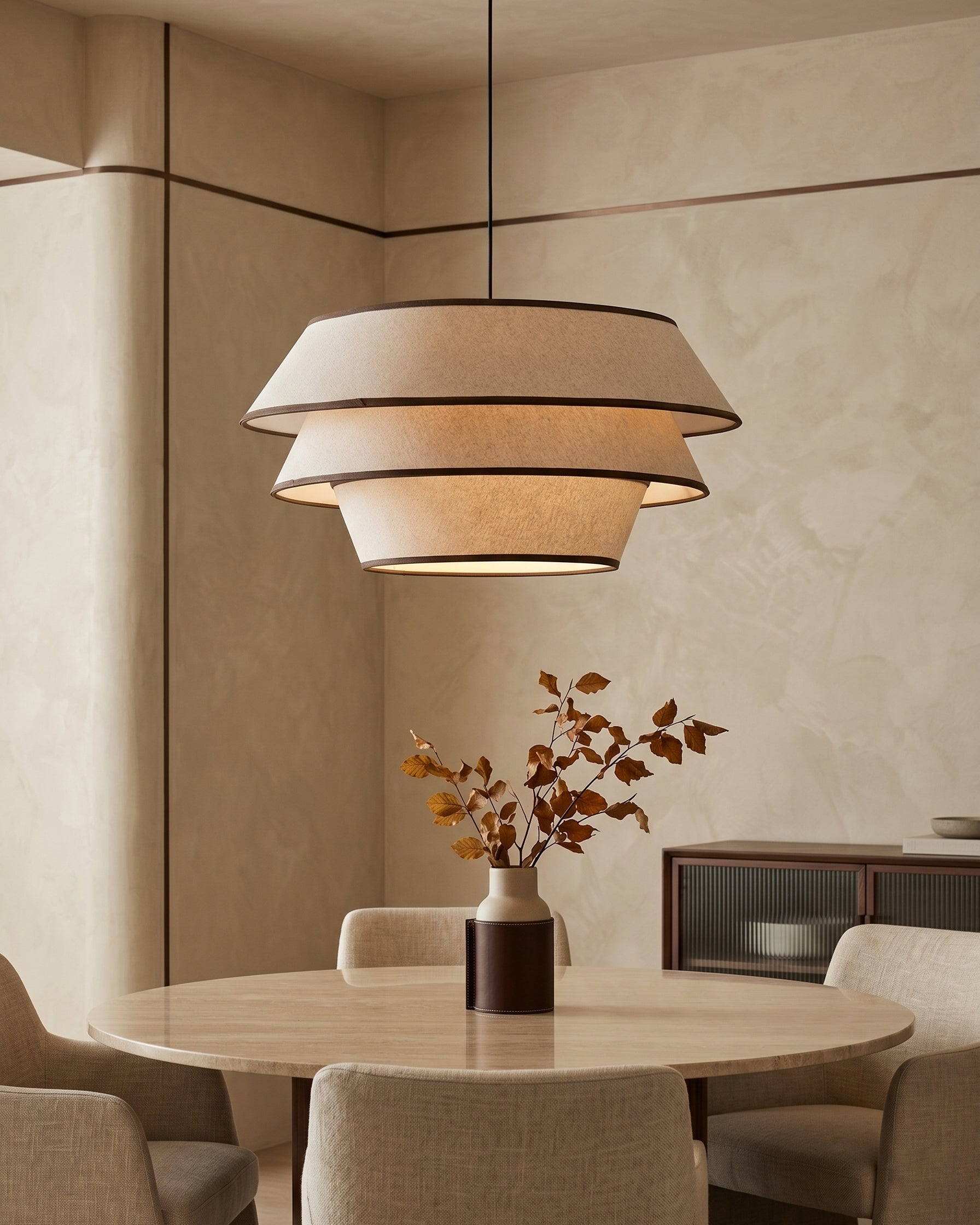 The Auden Pendant Light illuminated, casting a warm, ambient glow downwards.