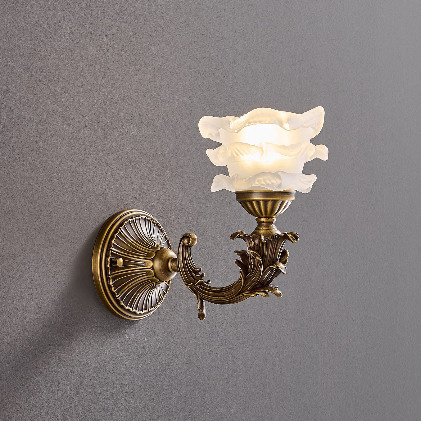 Close-up of the wall mounting plate in antique brass.