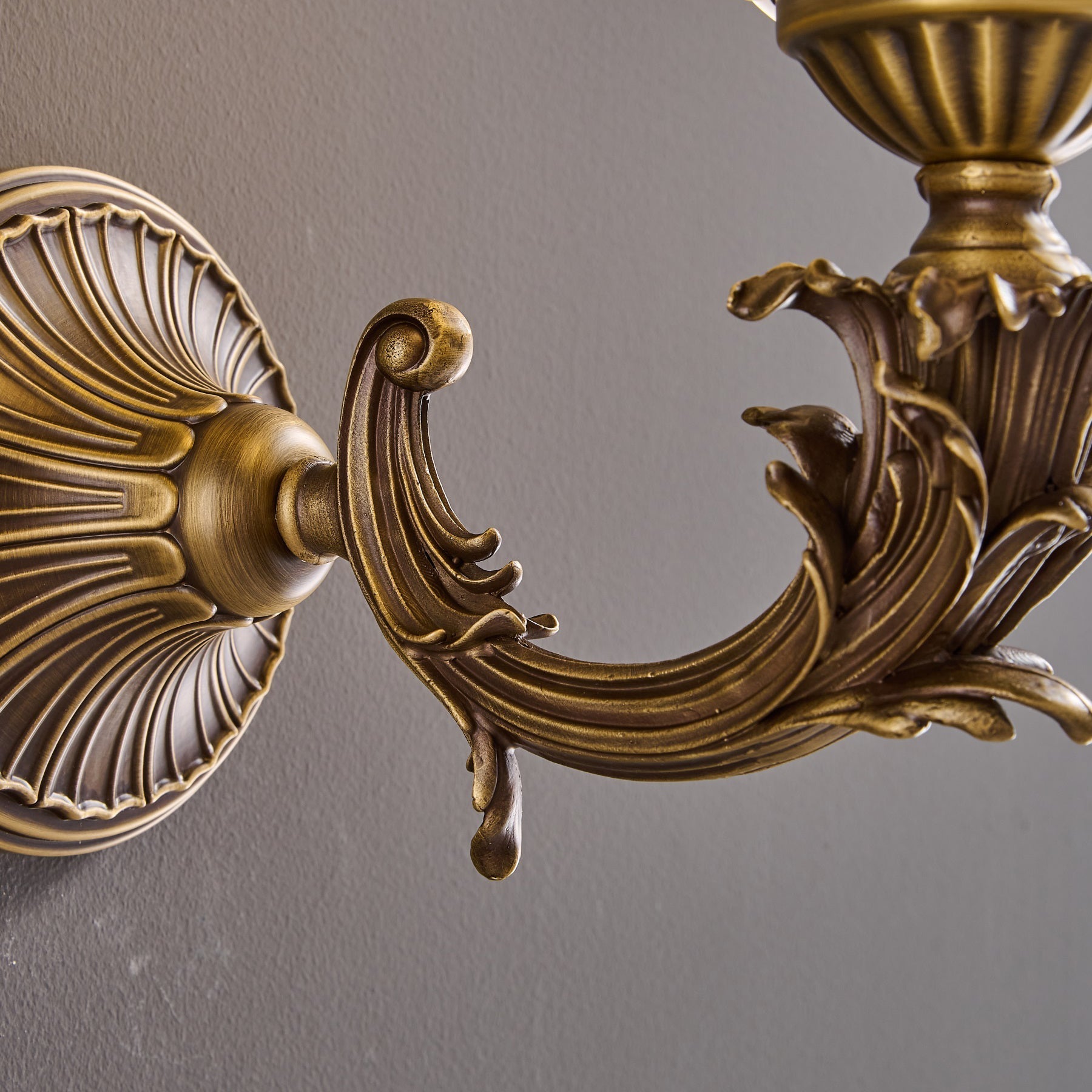 Detail of the decorative curve of the brass arm.