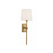 Dauphine Wall Sconce in Aged Brass finish against a neutral wall.