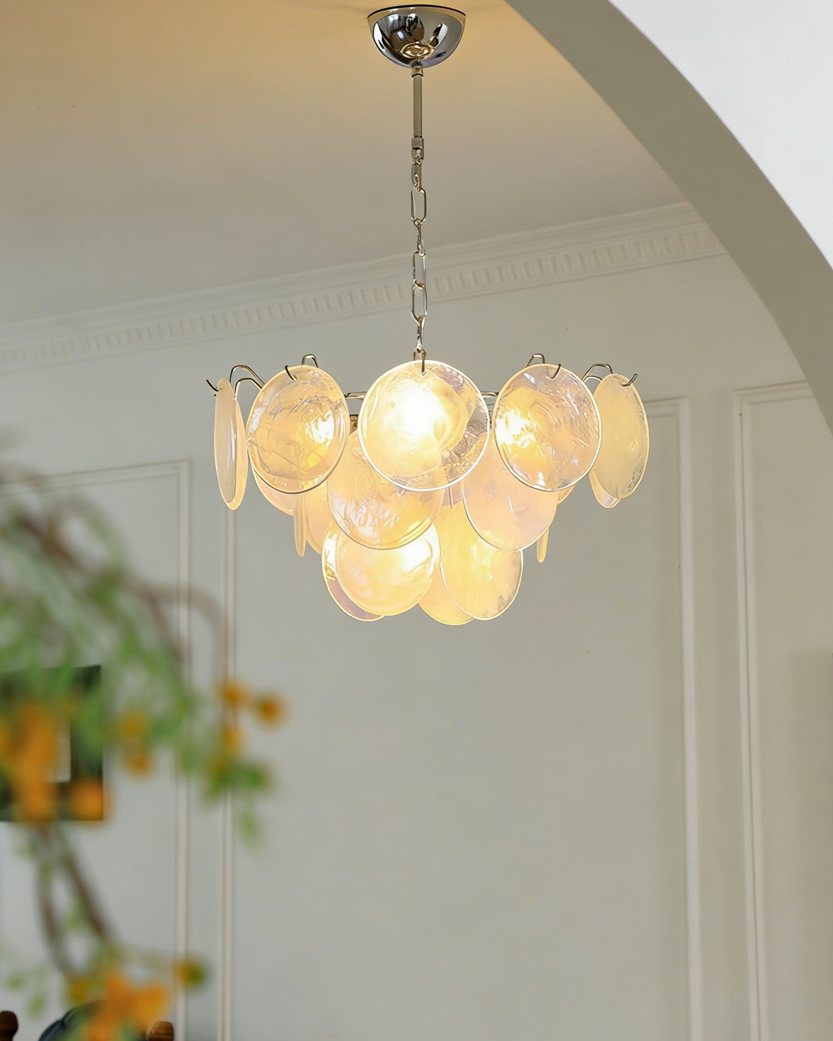 The Brette chandelier shown with white iridescent glass disks.