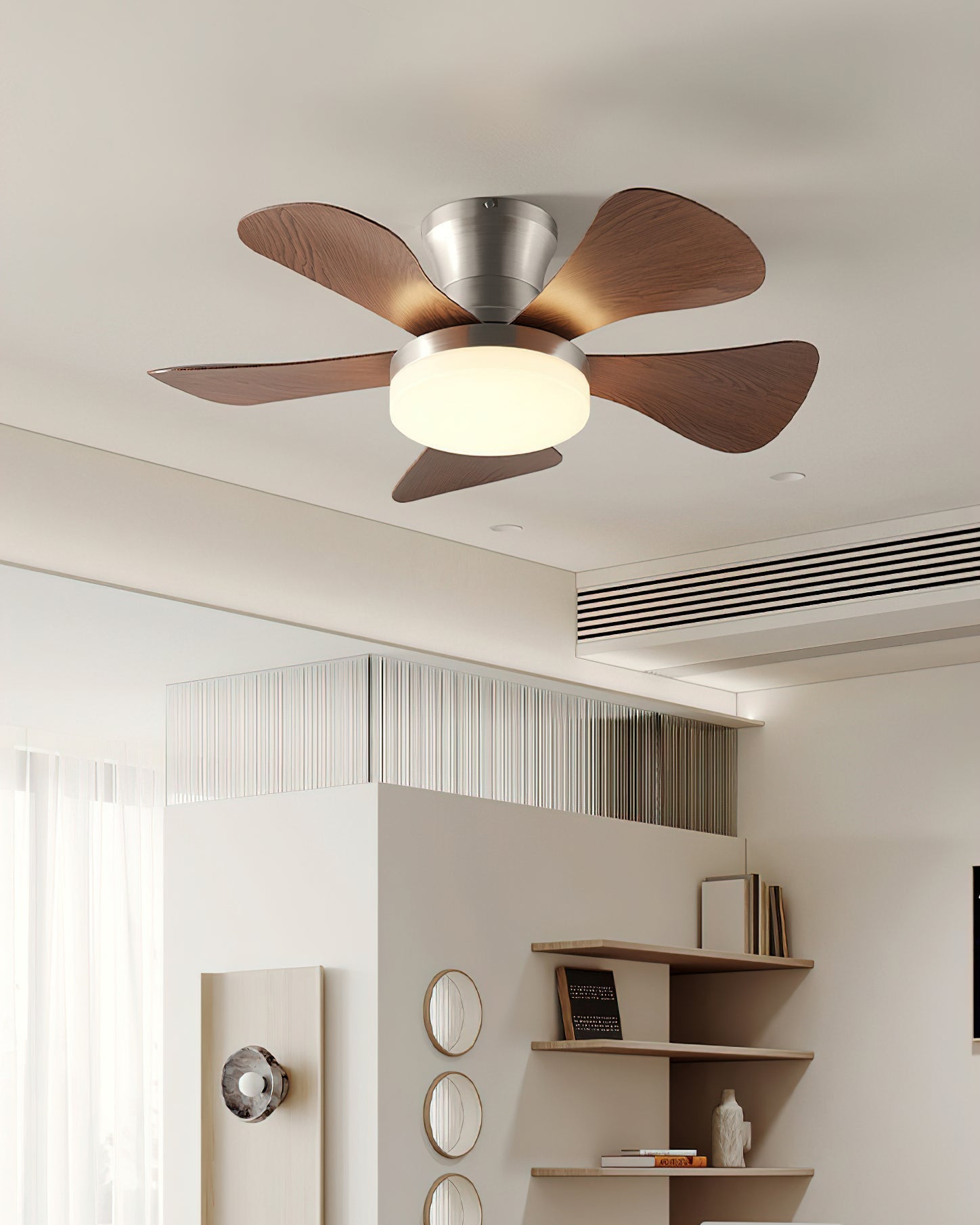 Hand holding the remote control for the Brennan Ceiling Fan Light.