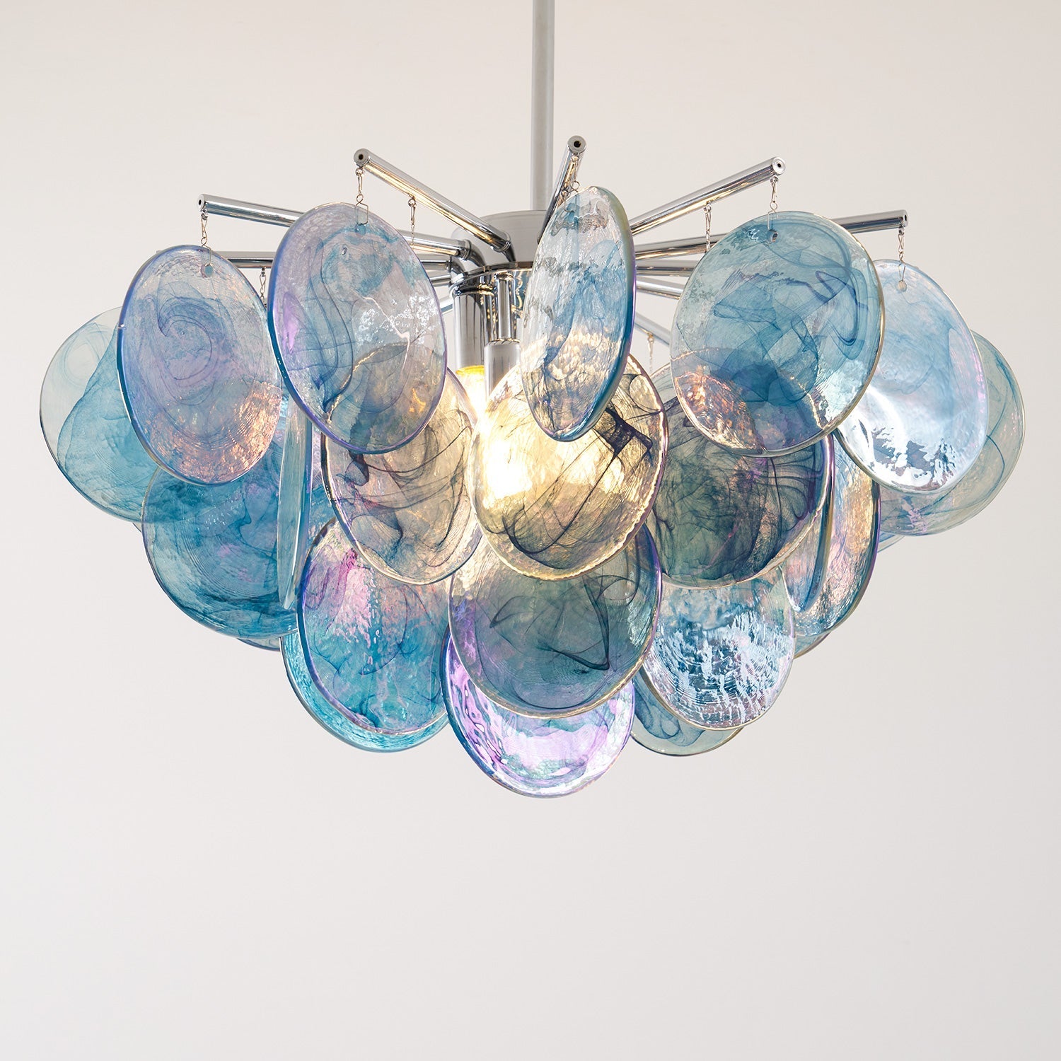 The Camisa Glass Chandelier in a commercial space like a lobby.