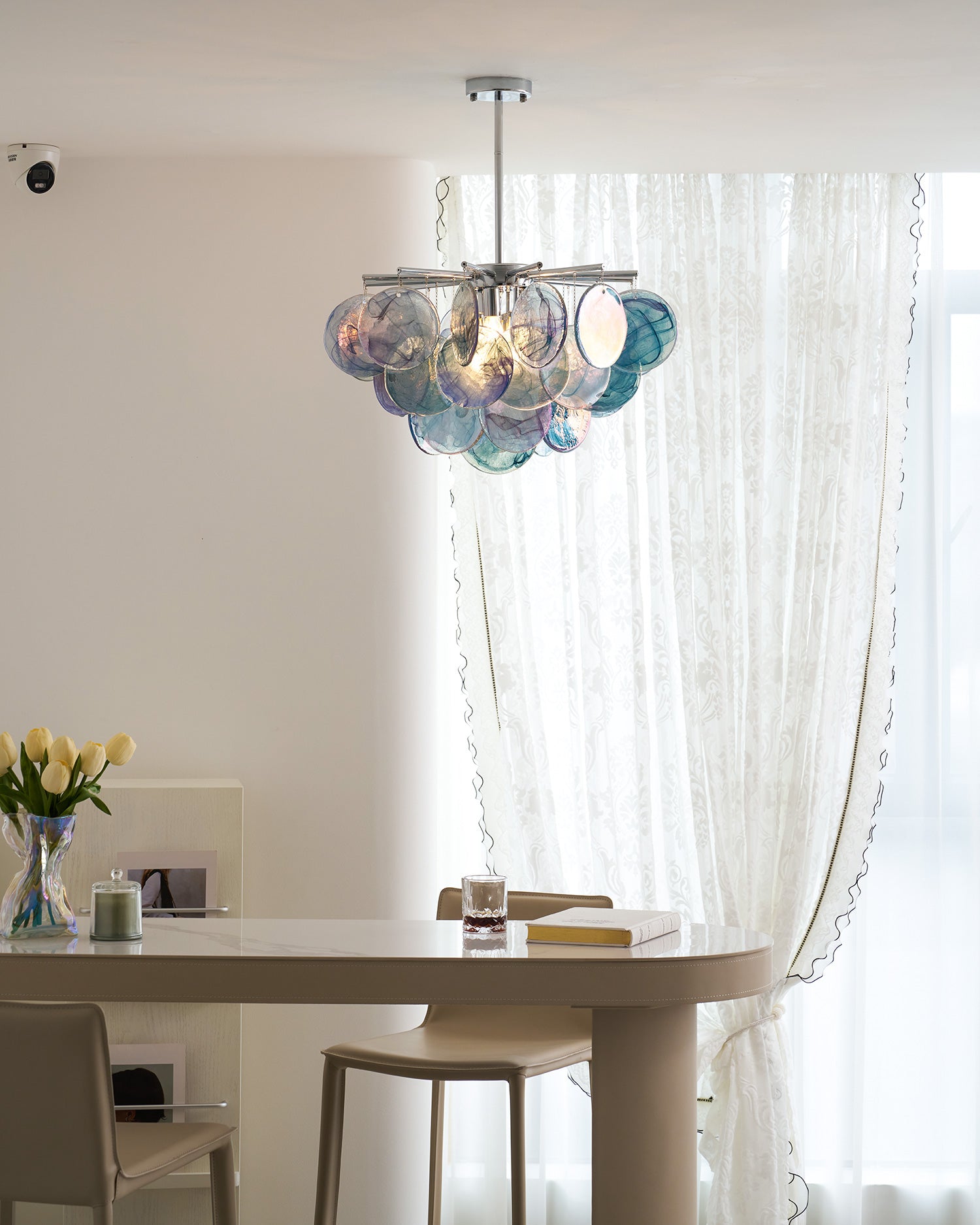 The Camisa Glass Chandelier in a minimalist interior.