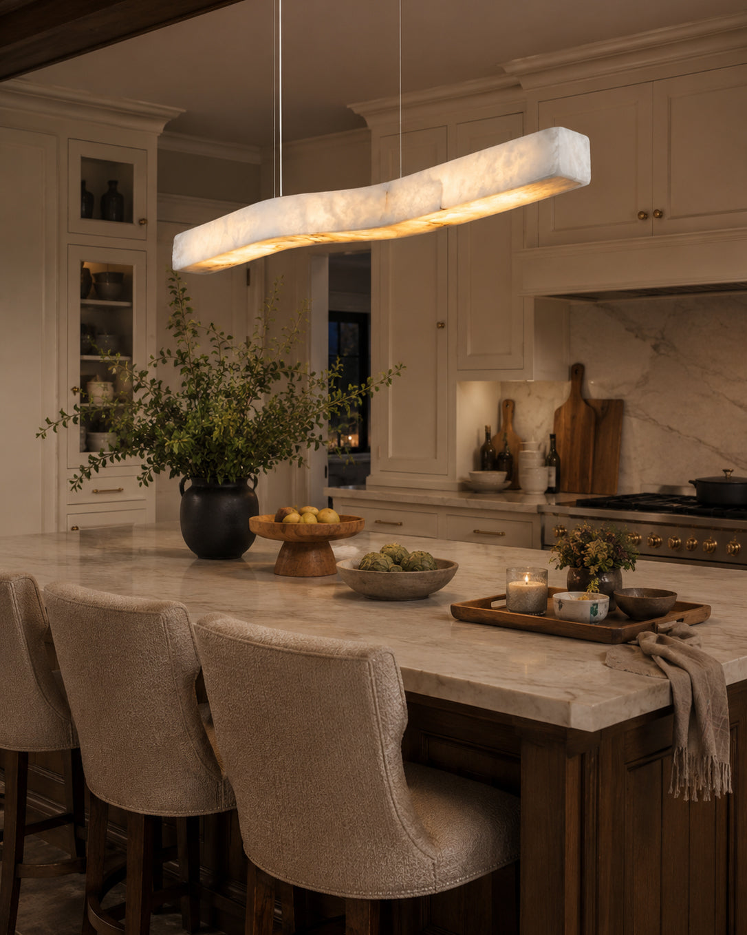 Angled view of the Camur chandelier highlighting its solid brass construction.