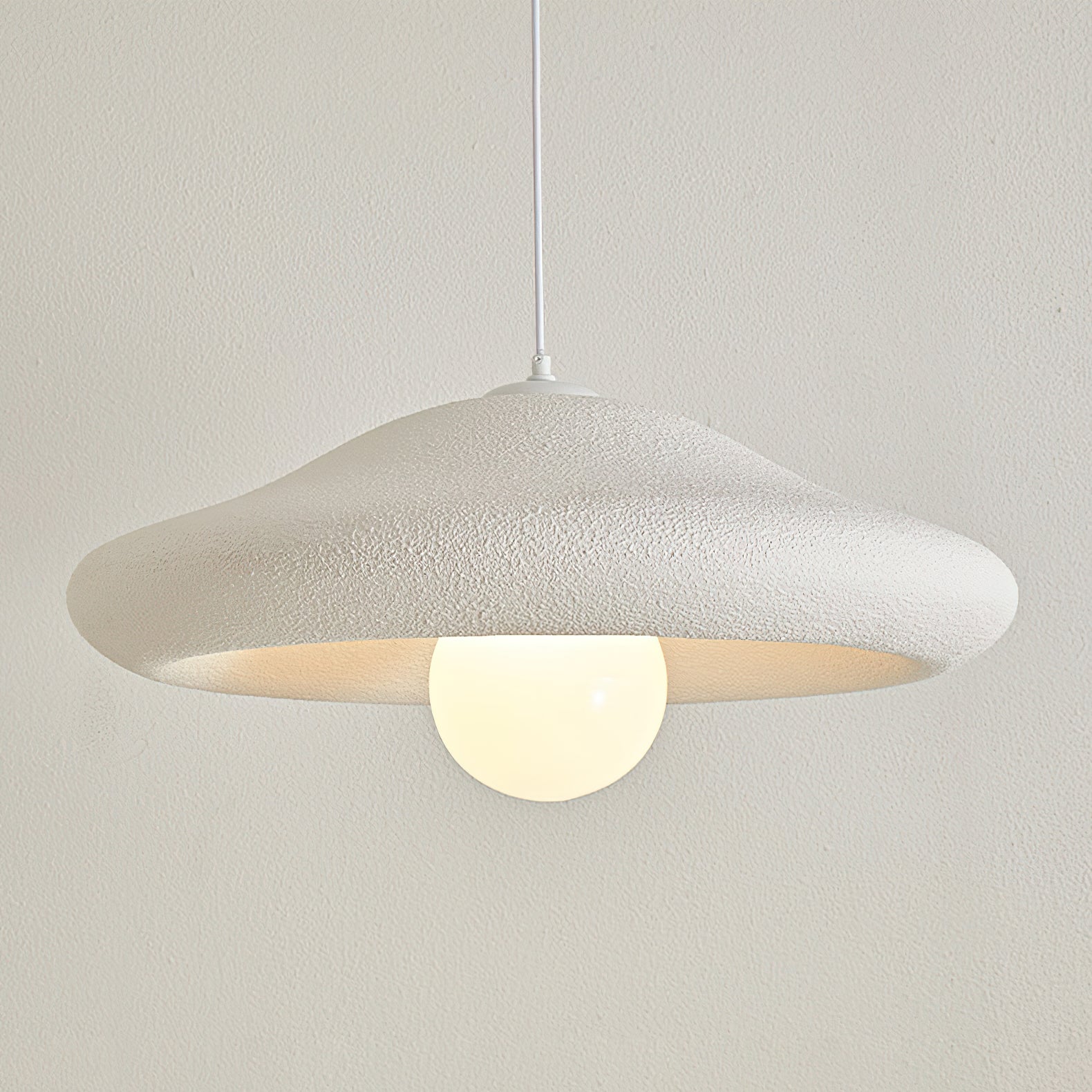 A lifestyle shot showing the scale of the Chalk Pendant Light in a room.