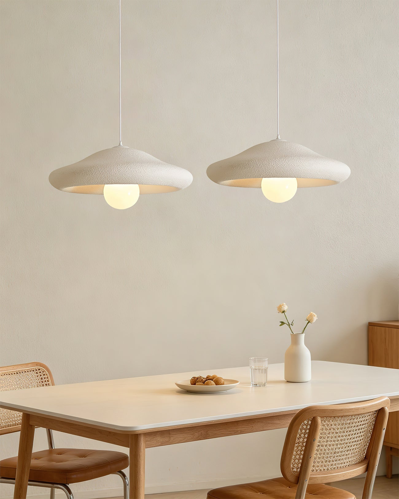 The Chalk Pendant Light hanging over a minimalist wooden dining table.