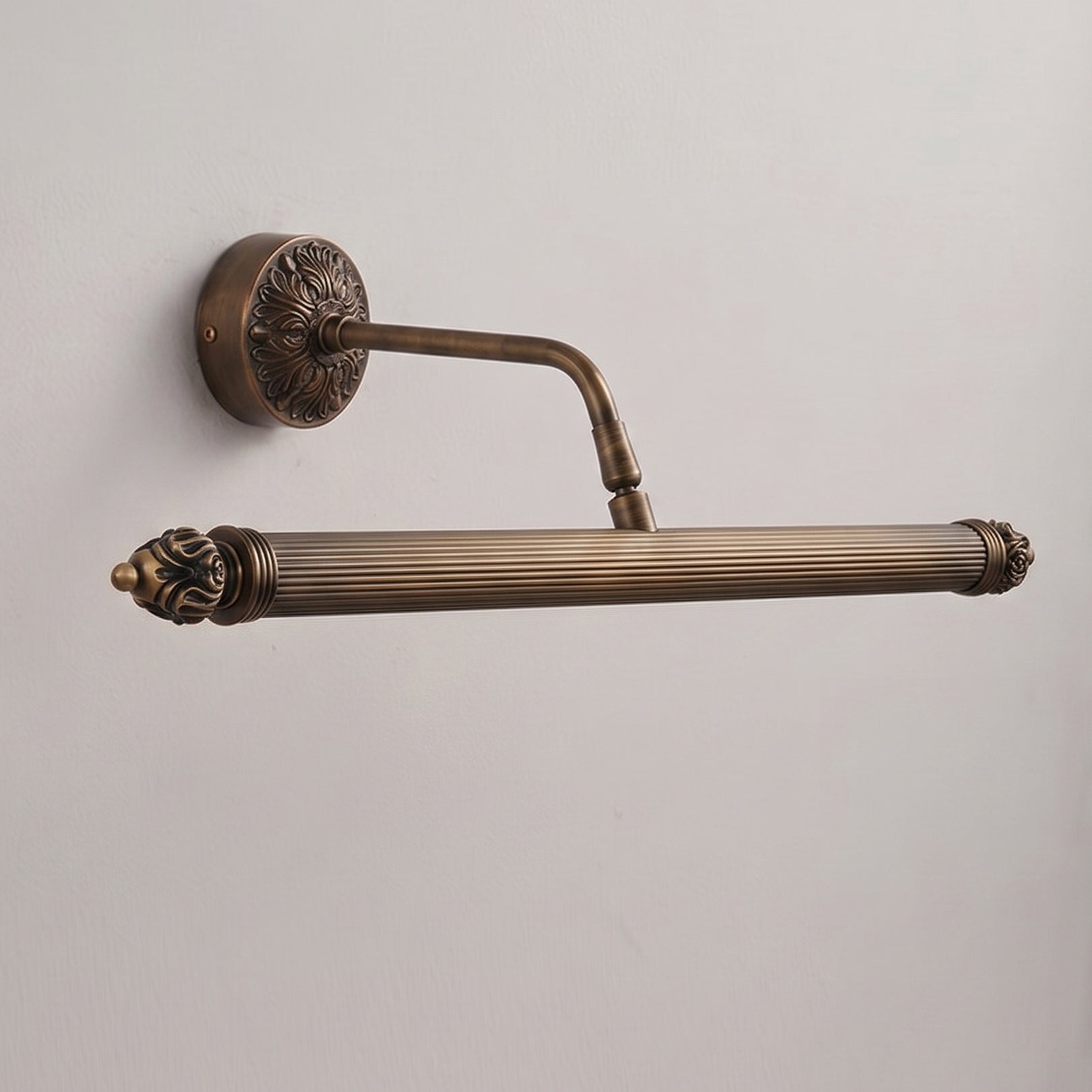 The sconce illuminating a dark wall, creating a warm glow.