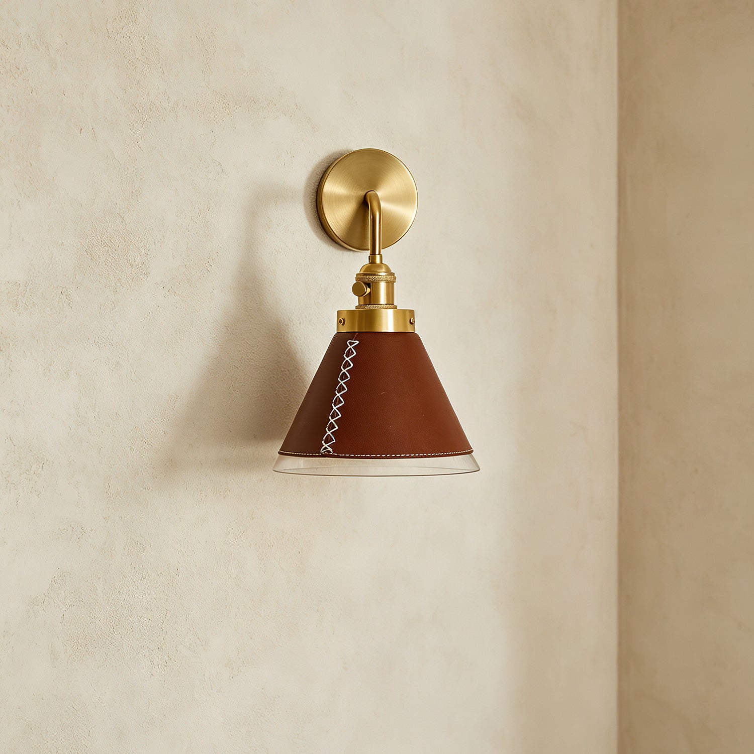 Cordoba Wall Sconce installed in a bedroom setting next to a bed.