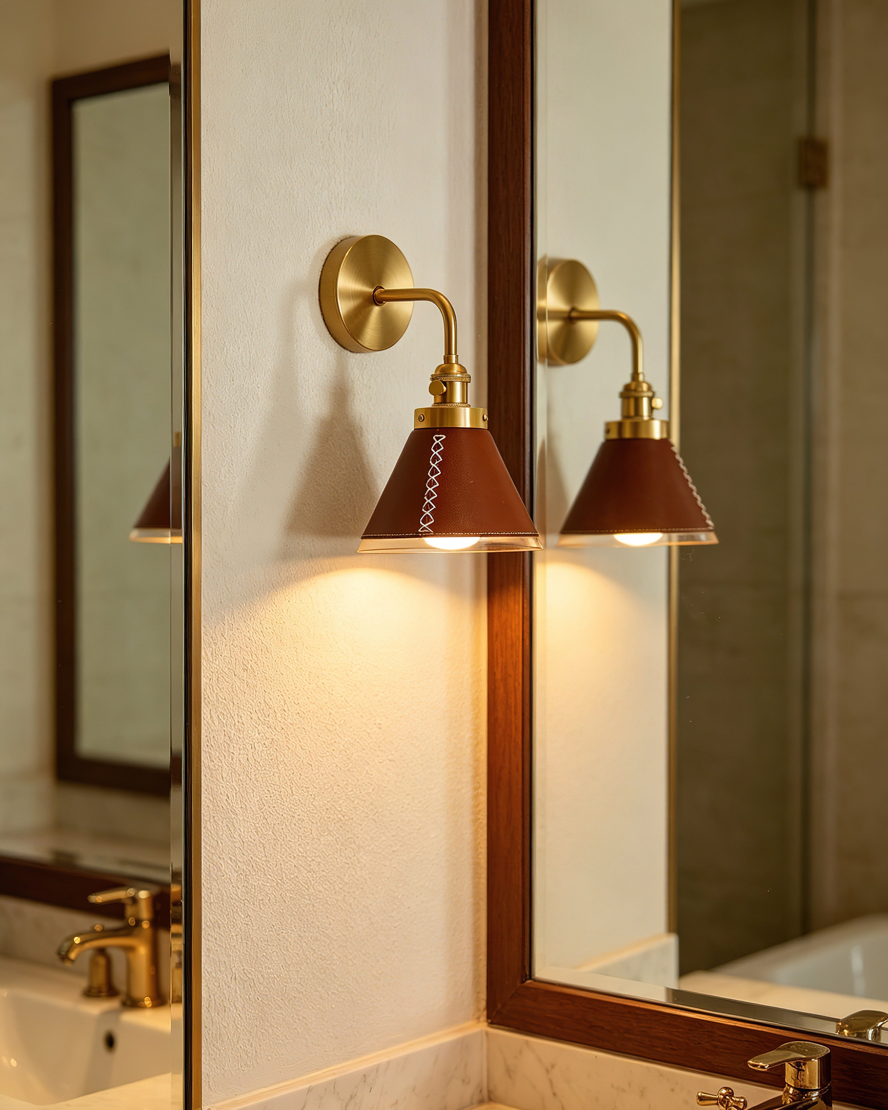 The Cordoba Wall Sconce illuminated, casting a warm downward light.