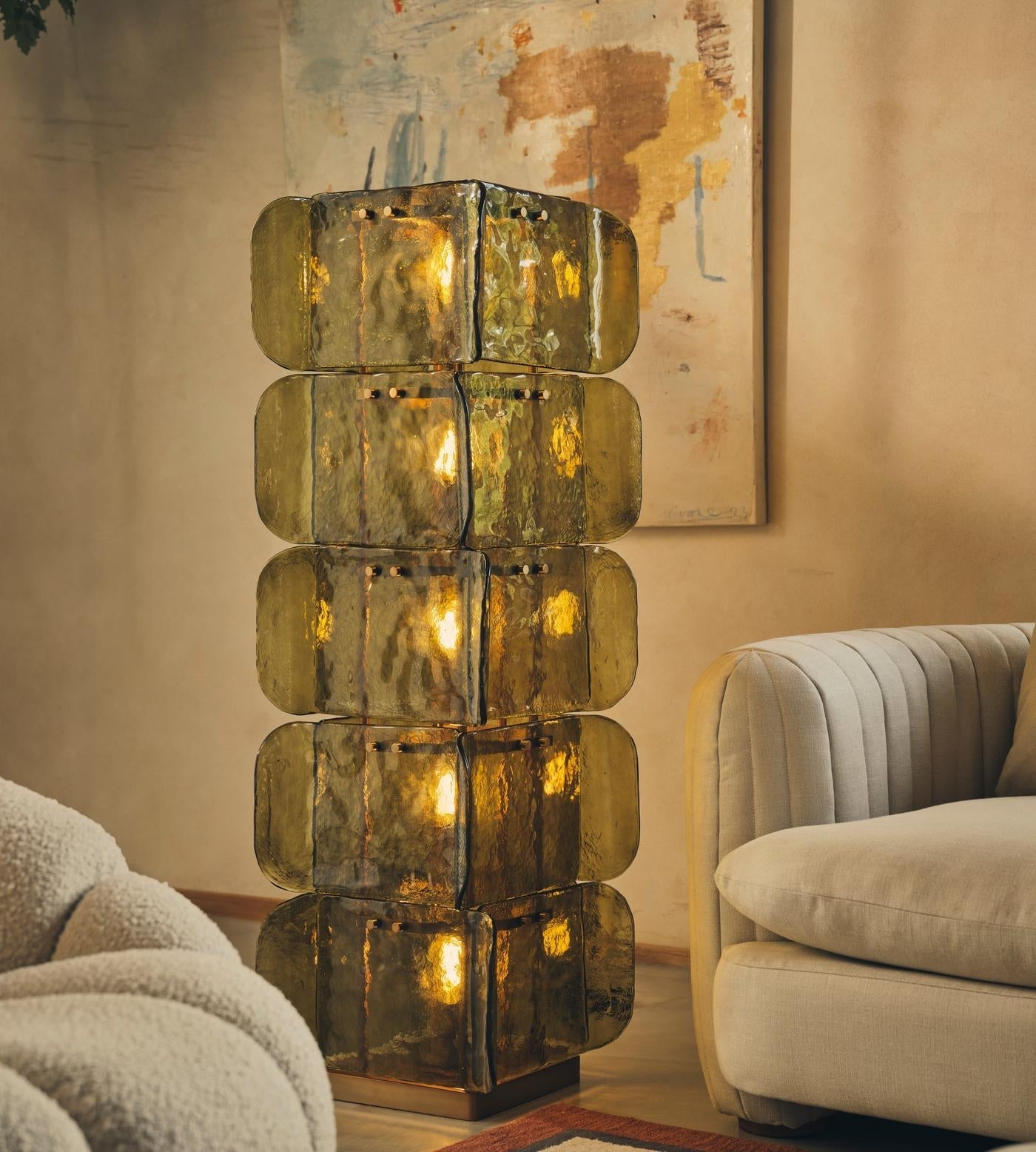 The gold finish of the Cubo Totem Floor Lamp.