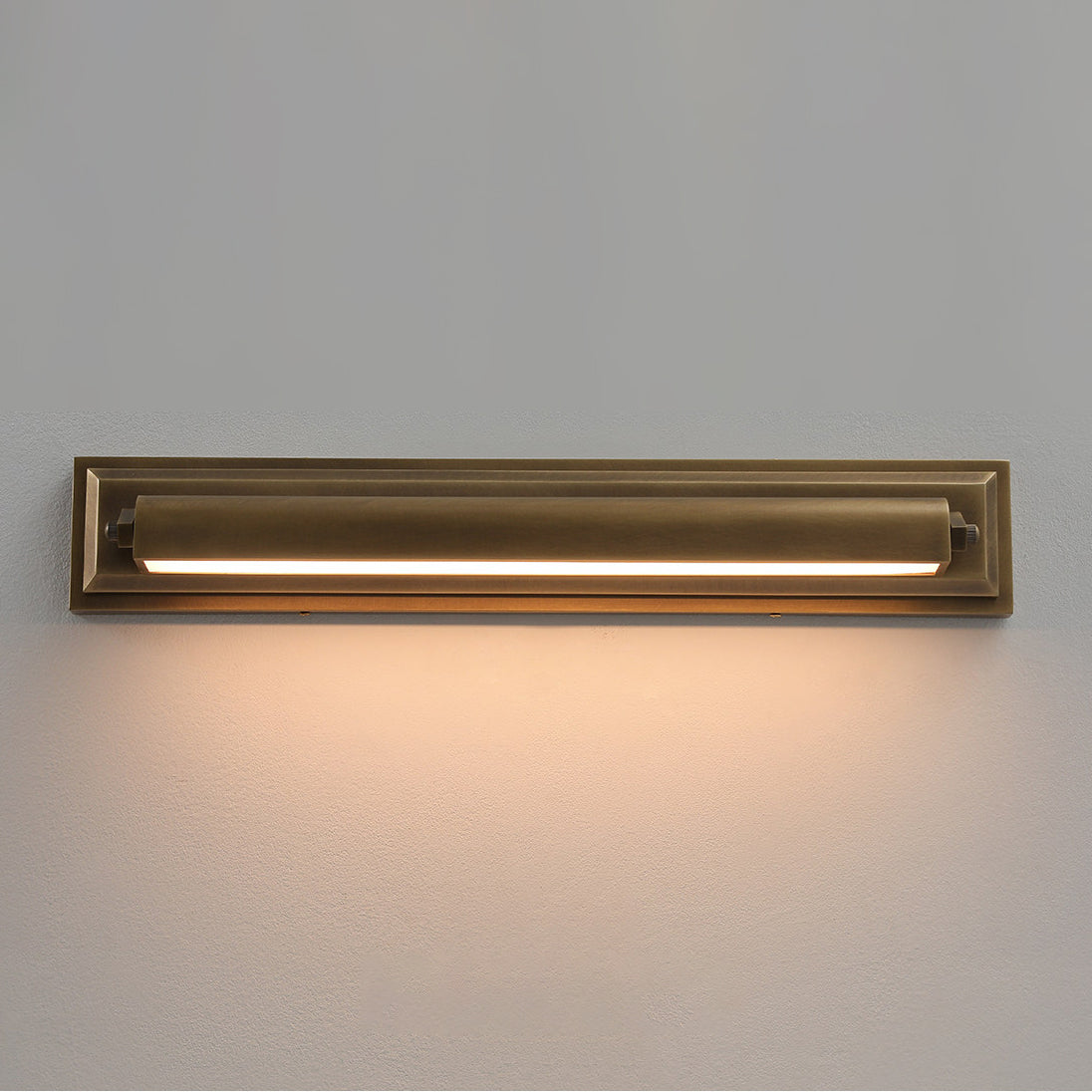 A pair of Davenport Wall Sconces mounted vertically on either side of a mirror.