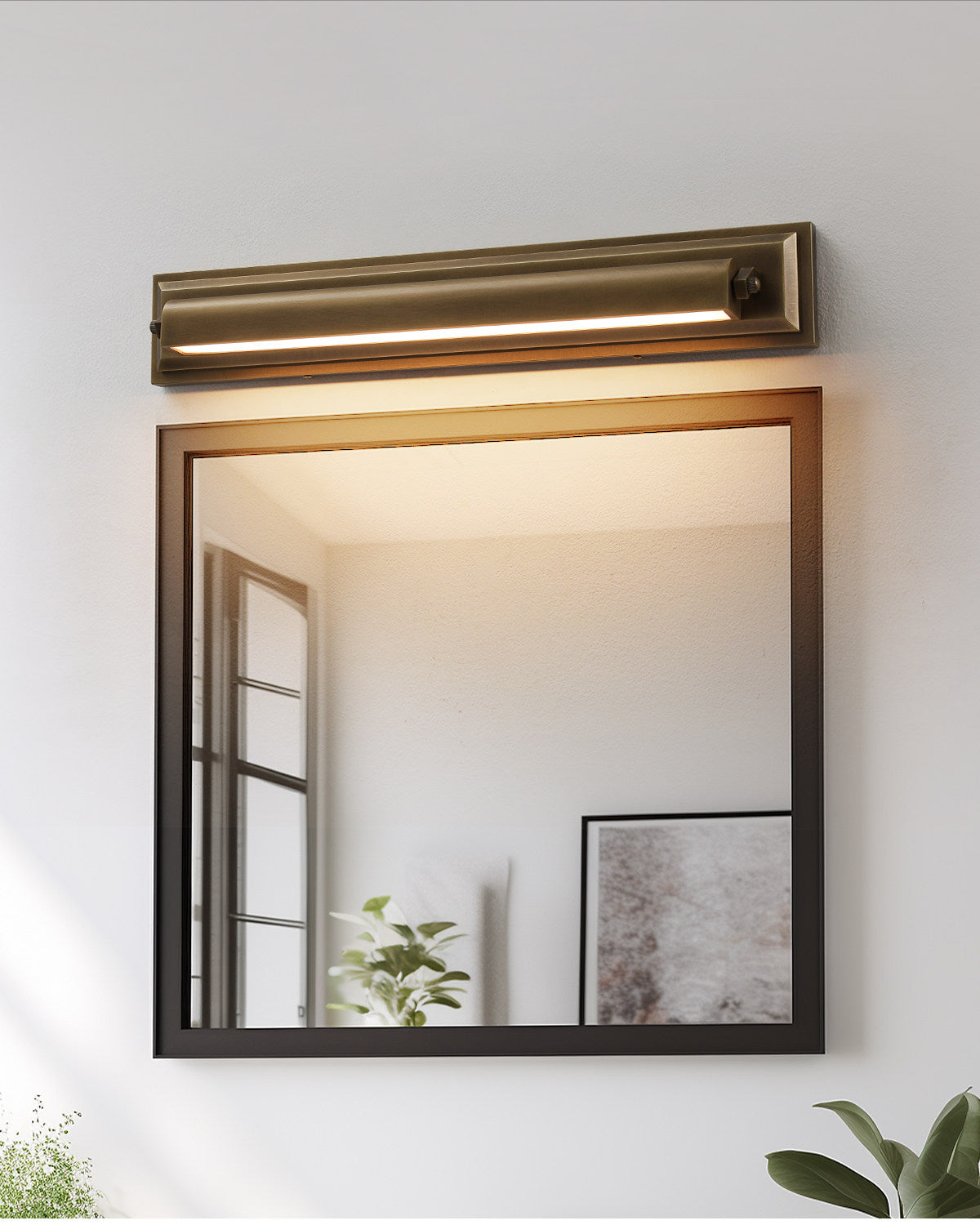 The wall sconce shown illuminating a hallway with a warm glow.