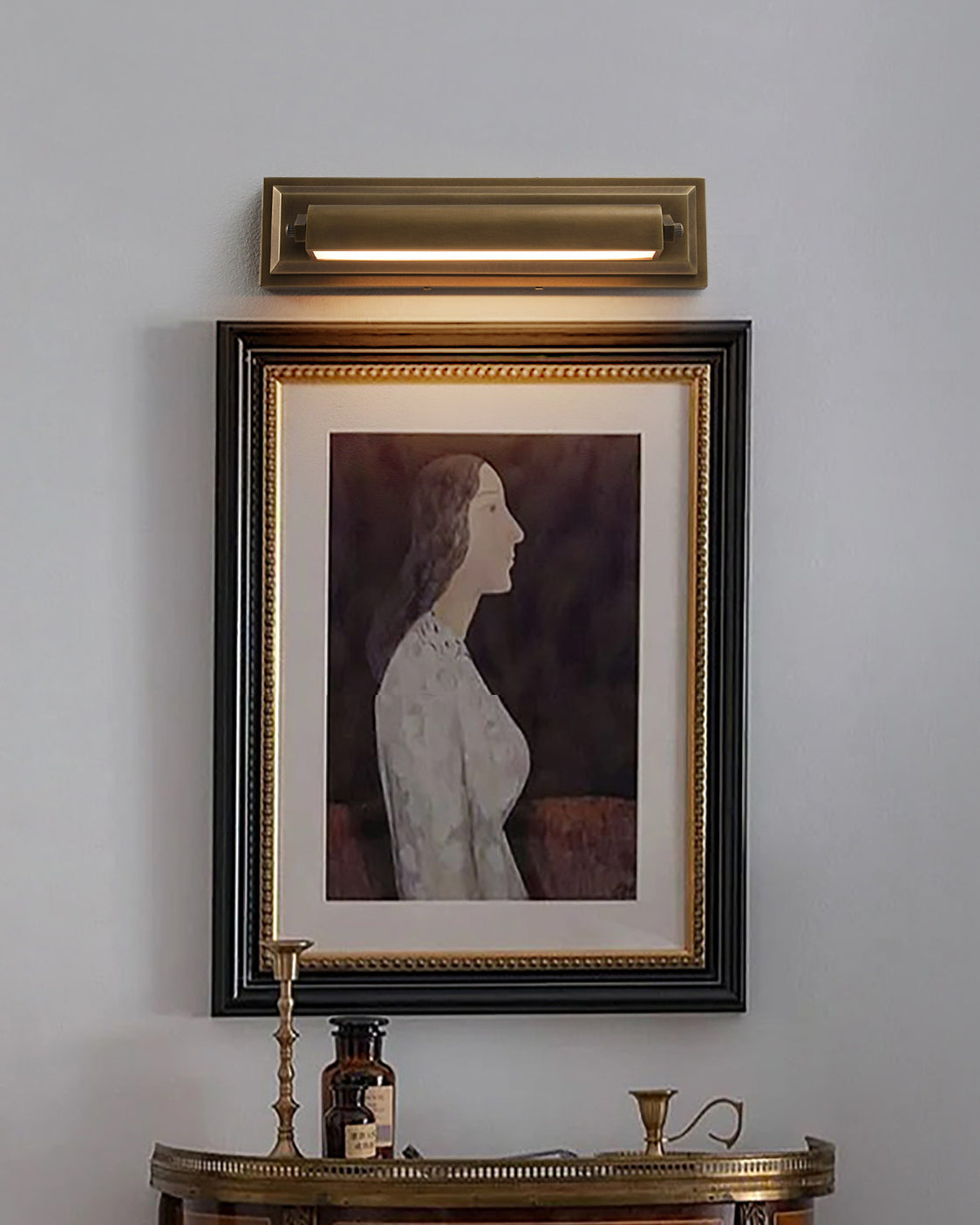 Detail shot of the brass material and antique finish of the wall sconce.