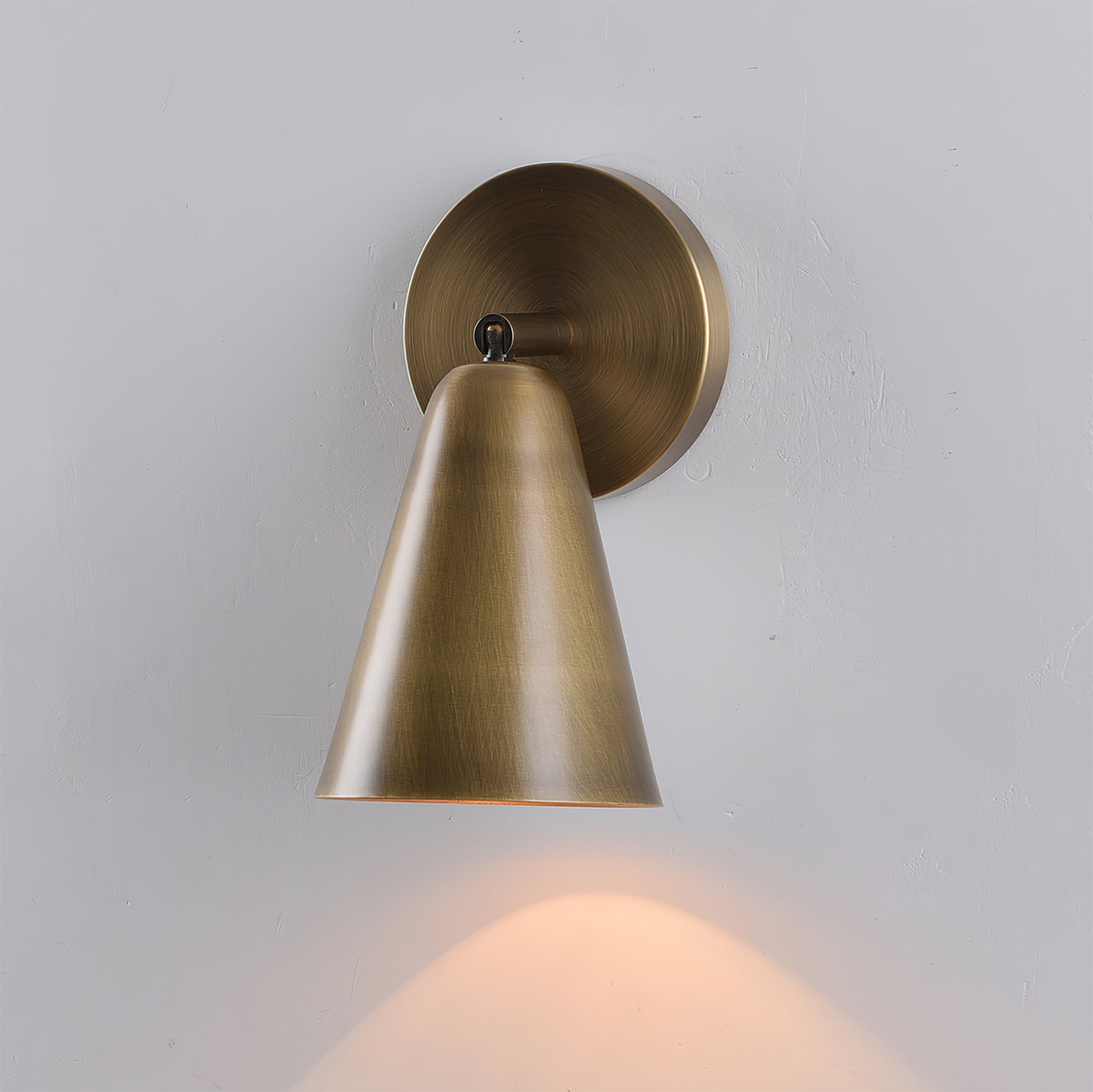 Close-up on the wall mounting plate of the sconce.